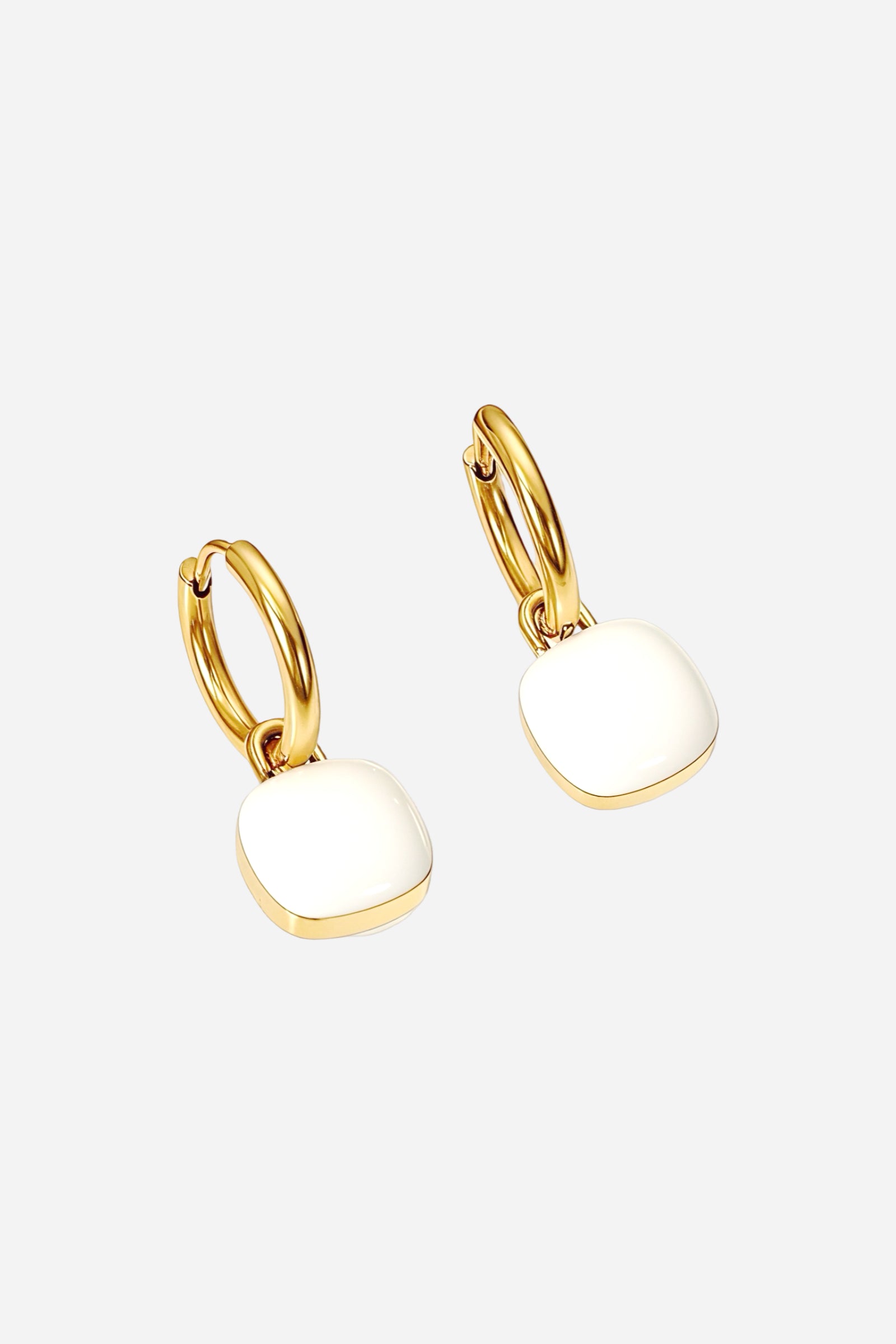 Side angle view of white charm drop hoop earrings crafted from stainless steel with a radiant PVD 18K gold plated finish, featuring smooth enamel square charms - GLISTIA.