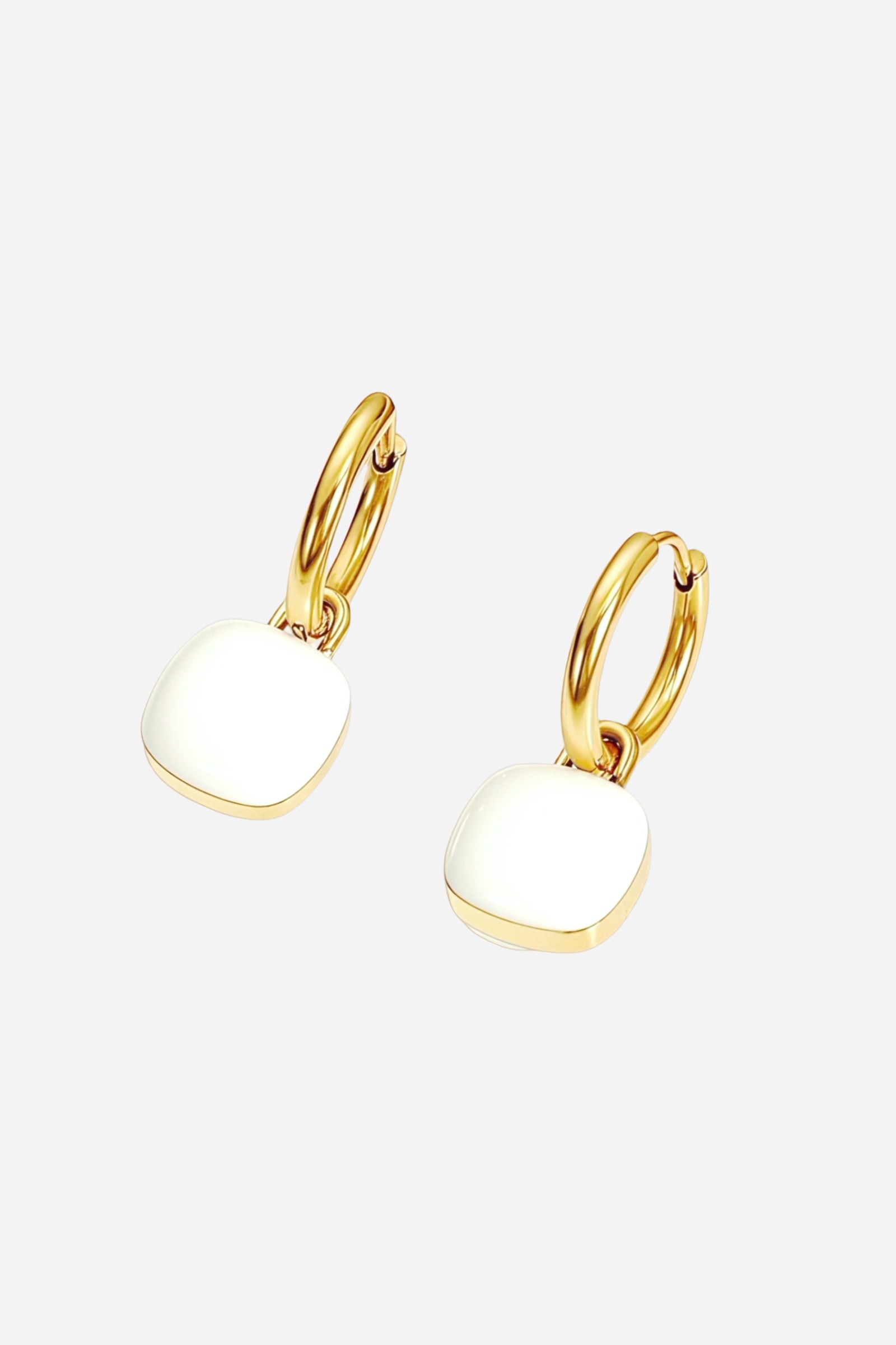Angled view of white square charm drop hoop earrings crafted from stainless steel with a lustrous PVD 18K gold plated finish, featuring smooth enamel charms - GLISTIA.