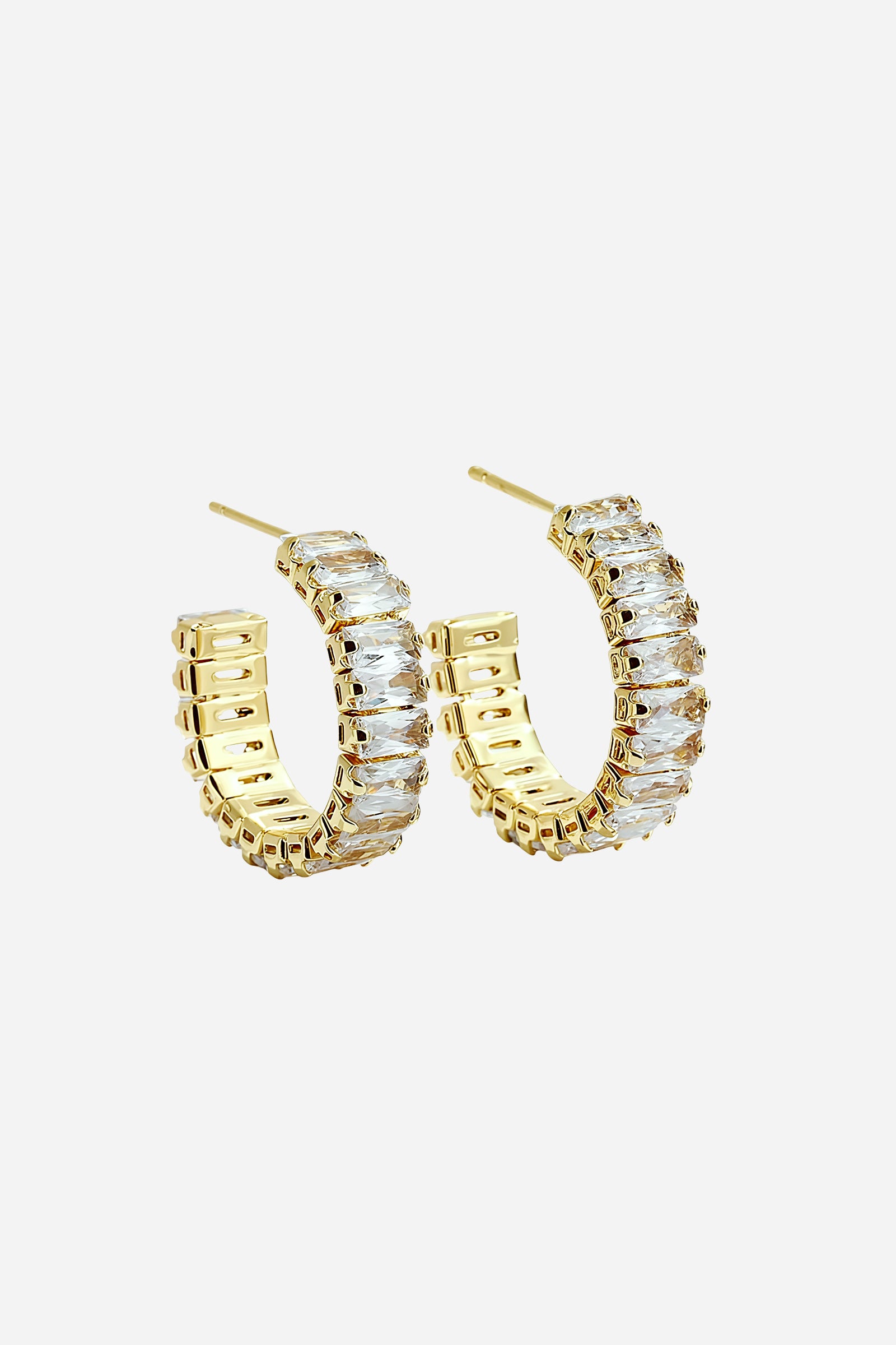 Top view of gold PVD zirconia C-hoop earrings showcasing curved design – GLISTIA