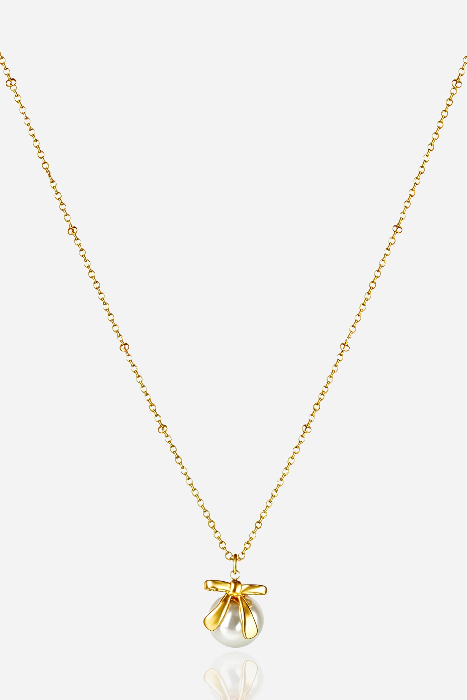 Zoom angle of GLISTIA 18K gold plated bow pendant featuring a smooth round simulated pearl.