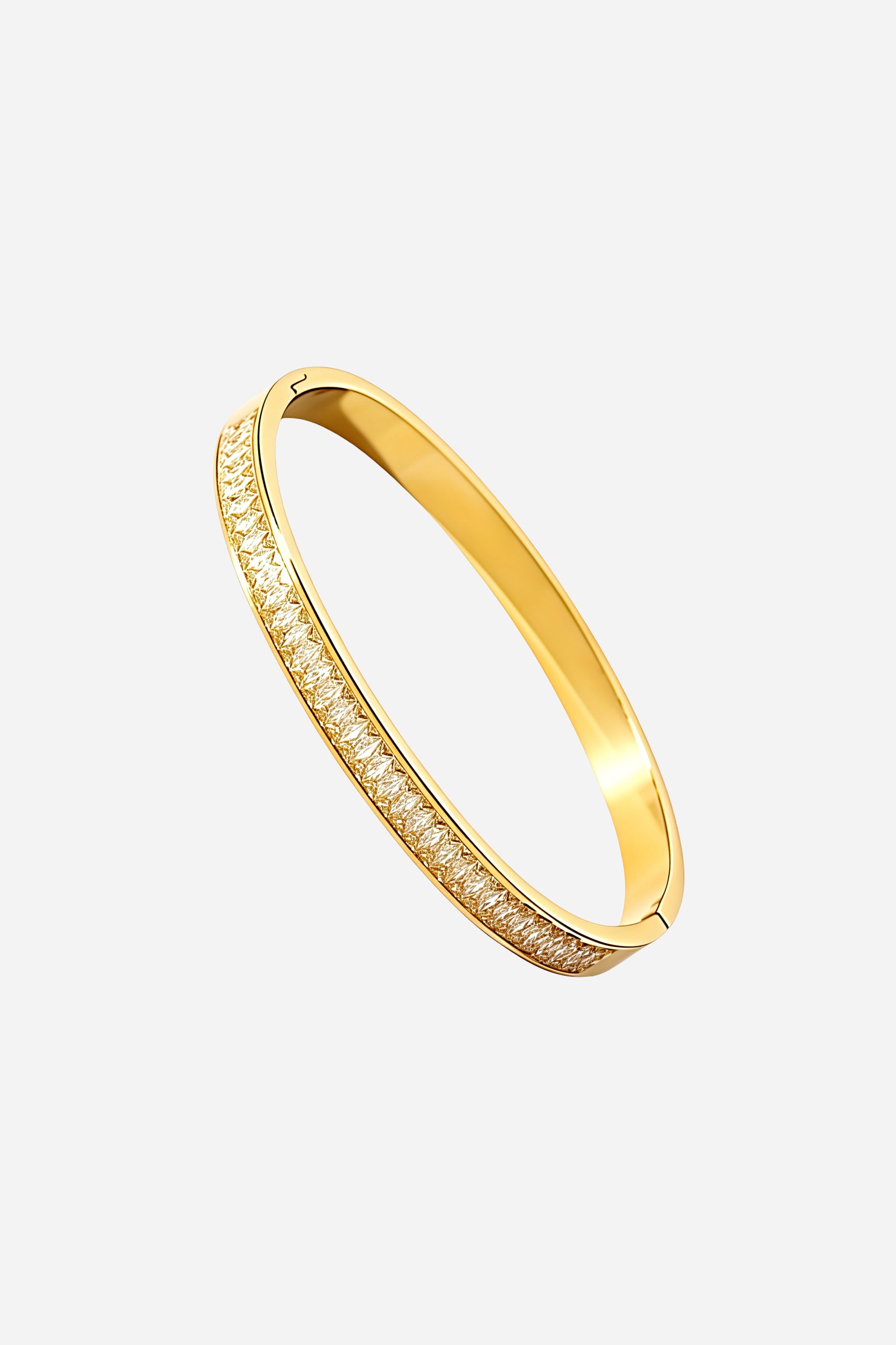 Side profile of GLISTIA 18K gold plated Baguette Crystal Line Bangle displaying the raised crystal channel and slim stainless steel body with mirror polish.