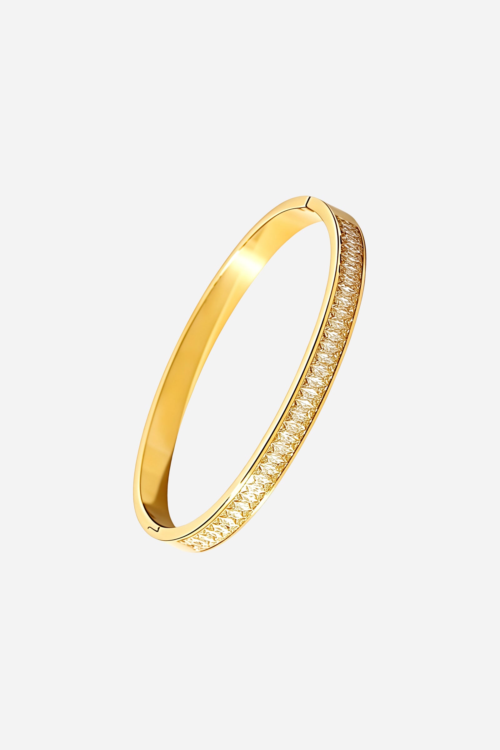 Top angle of GLISTIA gold baguette crystal bangle featuring a sleek circular design with evenly aligned crystal baguettes and a polished 18K gold finish.