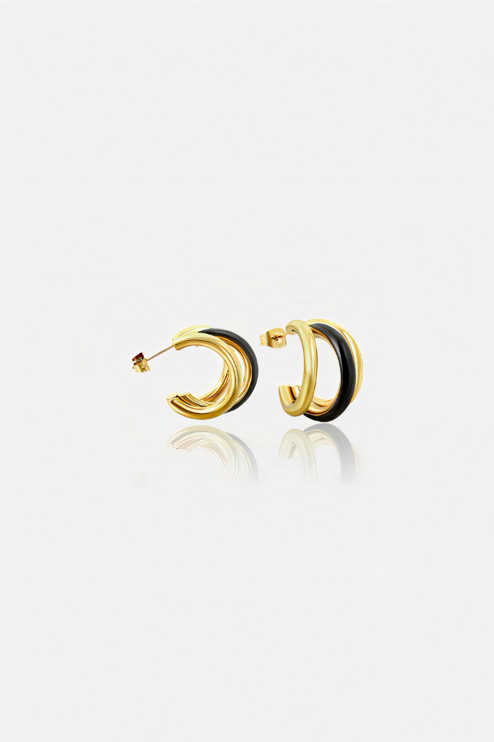 Side view of black and gold double C-hoop earrings in PVD 18K gold plated stainless steel with glossy black enamel – elegant modern design by GLISTIA