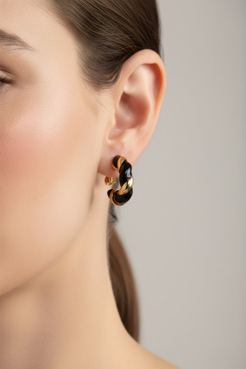 Black and gold twist C-hoop earrings crafted from stainless steel with 18K PVD gold plating and contrasting black enamel finish