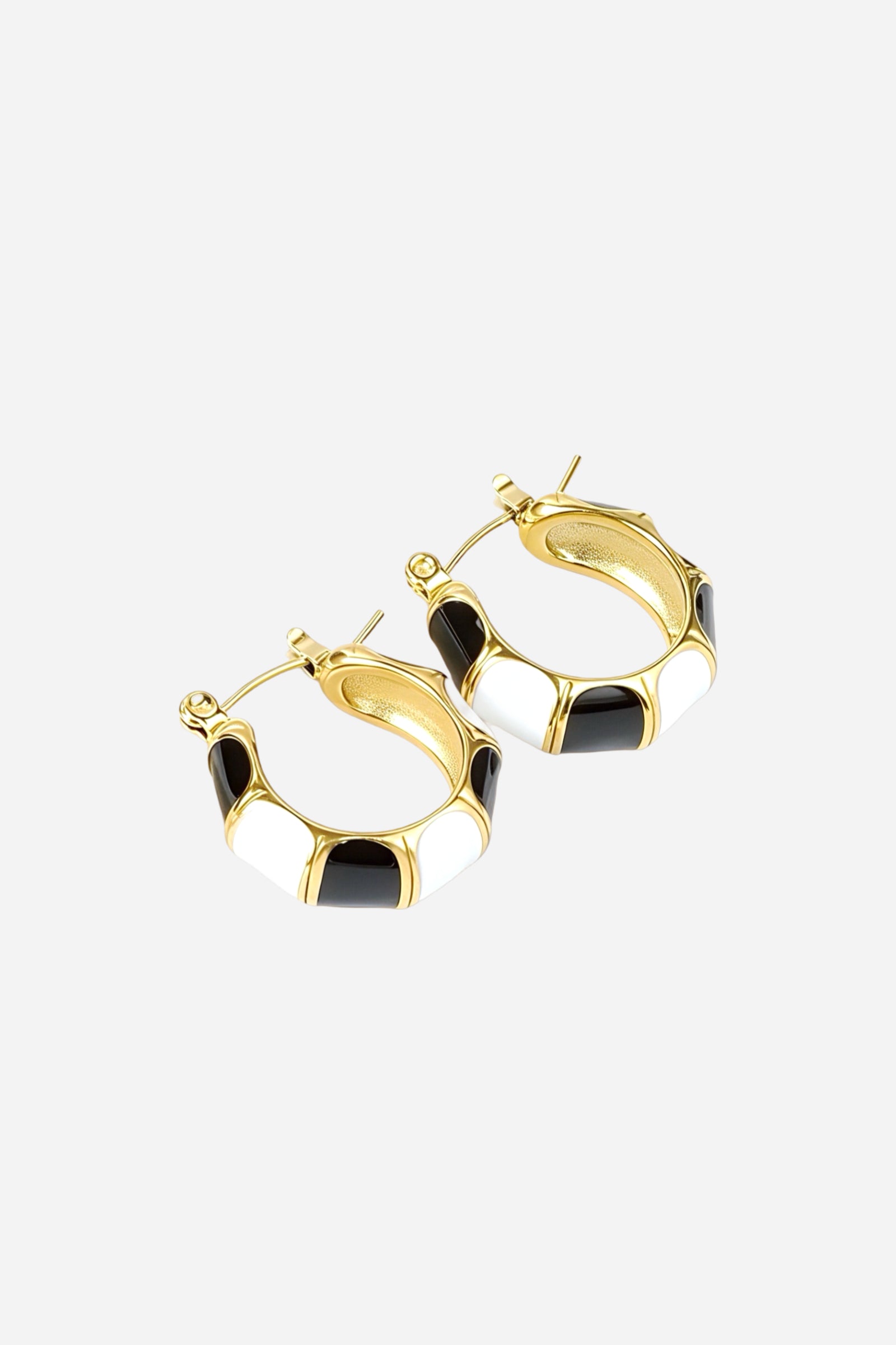 Top view of black and white enamel hoop earrings in 18K gold plated stainless steel featuring alternating enamel panels and polished gold accents – GLISTIA jewellery
