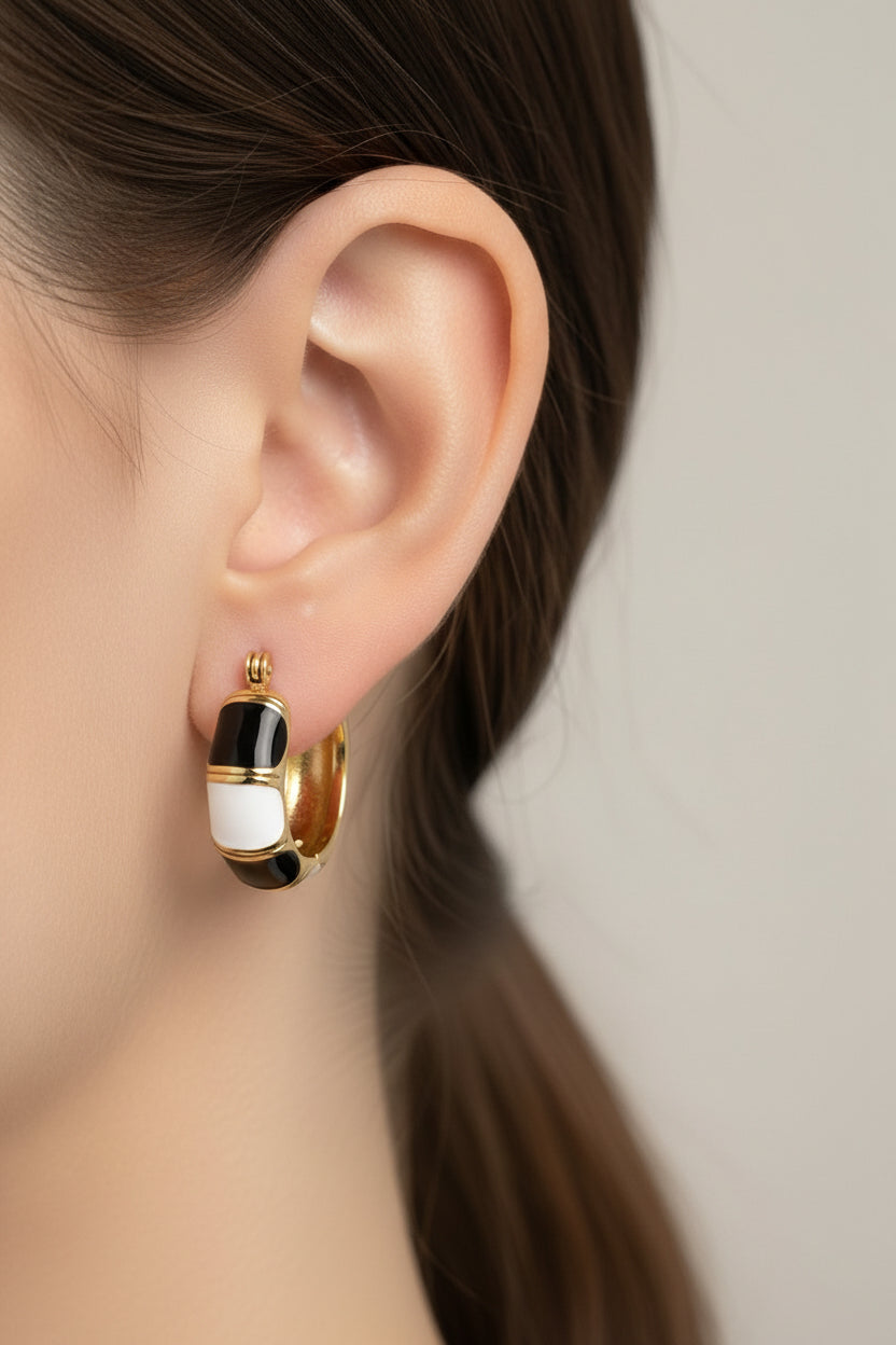 Side view of black and white enamel hoop earrings with 18K PVD gold plating, water safe and tarnish resistant jewellery by GLISTIA
