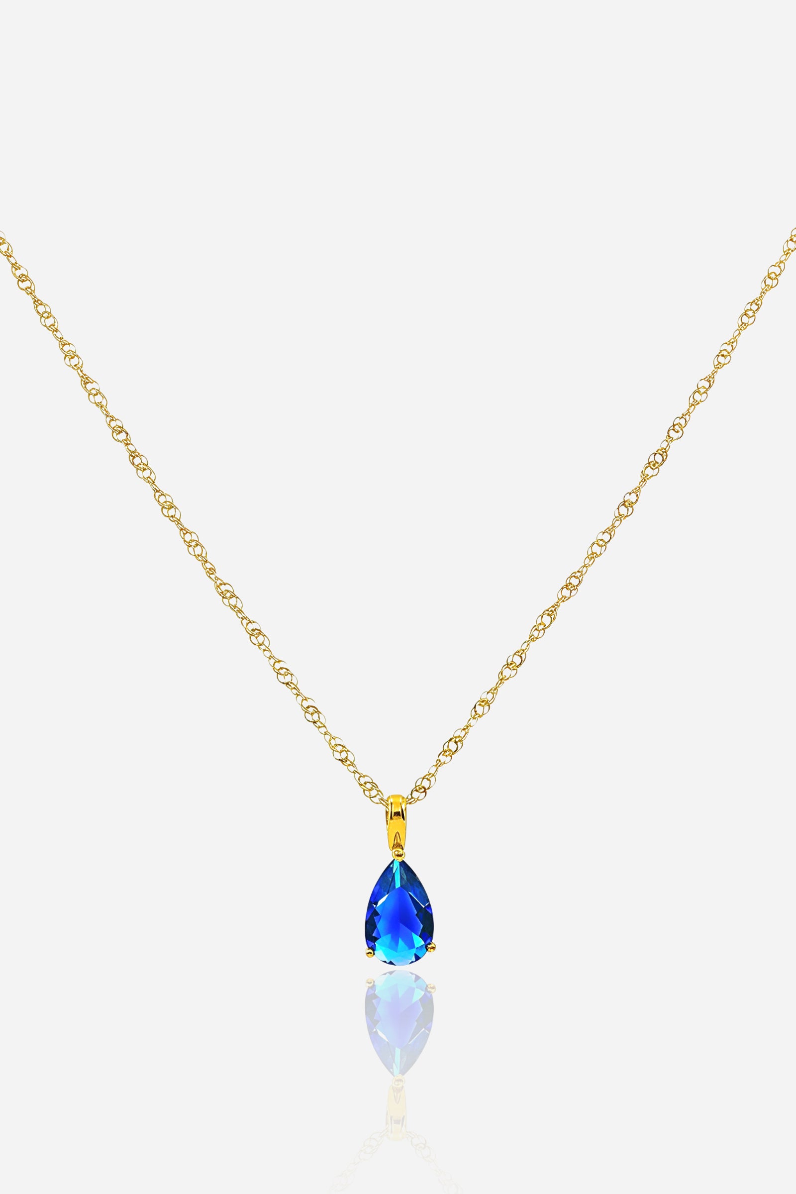 Zoom view of Blue Zircon Birthstone Necklace December – pear-cut blue zircon and 18K PVD gold-plated pendant by GLISTIA.