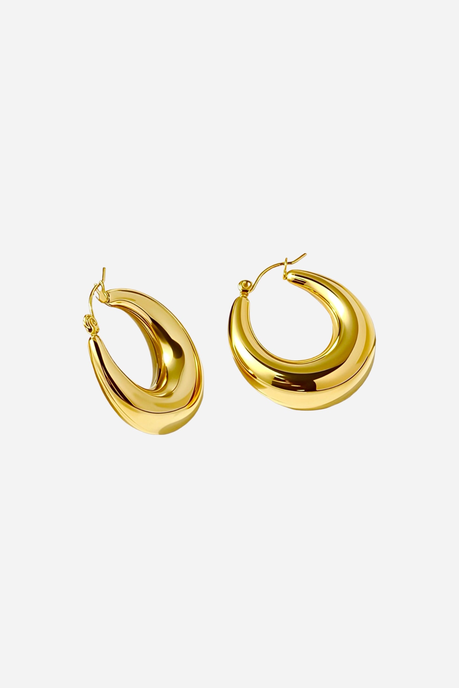 Bold crescent hoop earrings crafted from premium stainless steel and finished in polished PVD 18K gold plating, featuring a smooth curved silhouette with a mirror-like shine – GLISTIA.