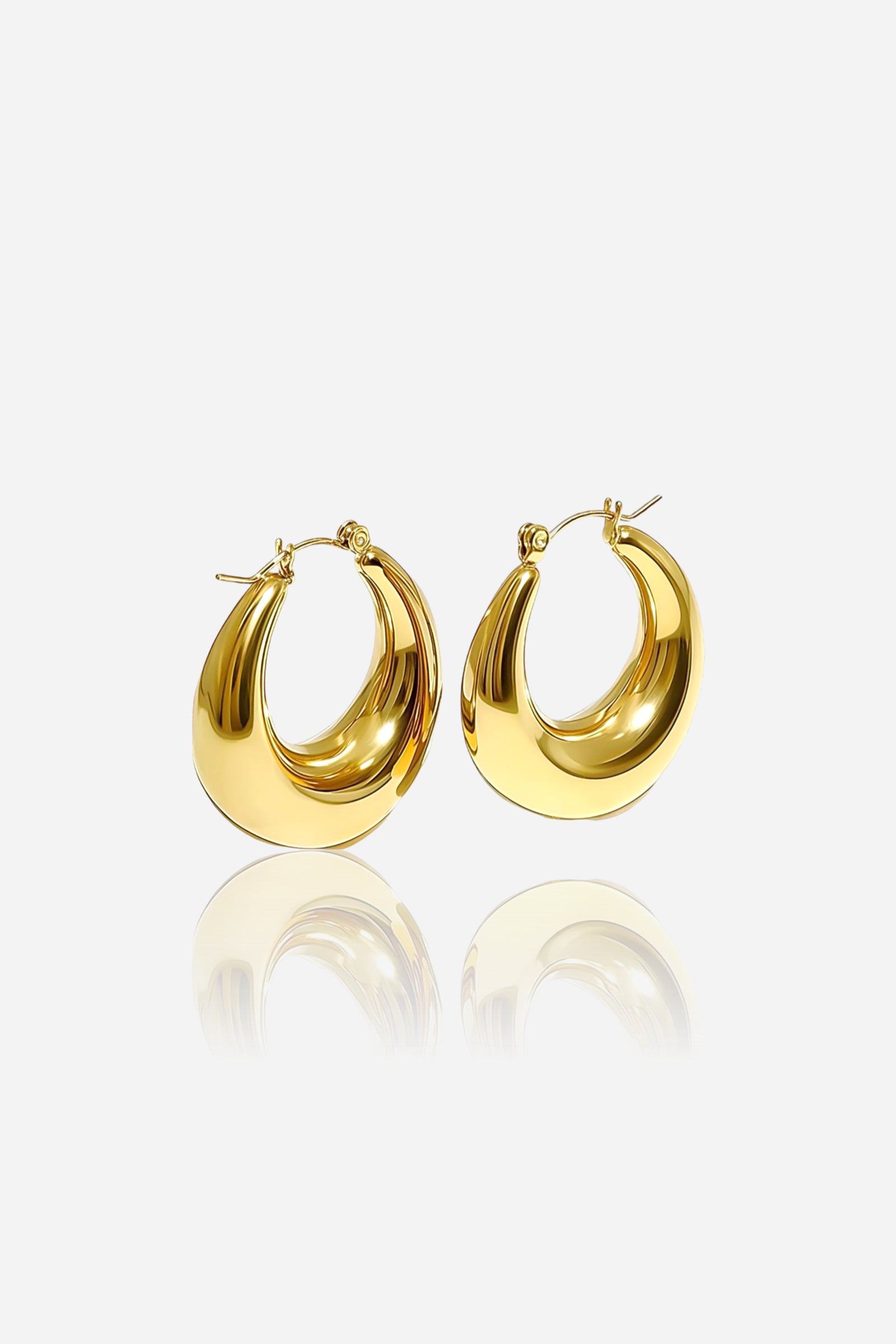 Front view of bold crescent-shaped hoop earrings crafted from stainless steel with a high-shine PVD 18K gold-plated finish, reflecting modern elegance and sculptural curves – GLISTIA.
