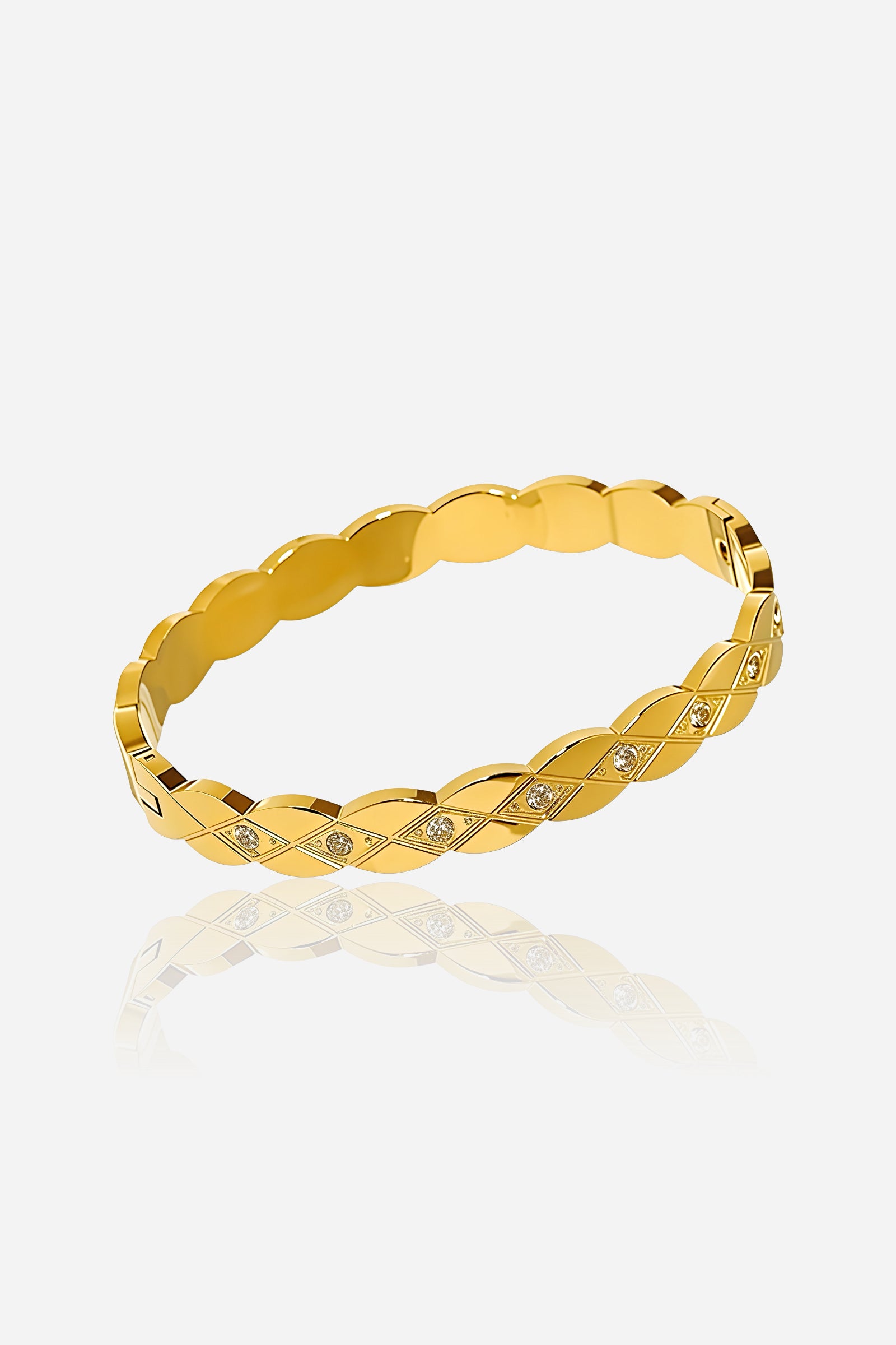 Top angle of GLISTIA braided crystal bangle showcasing interwoven gold links and sparkling cubic zirconia stones in a polished 18K PVD gold finish
