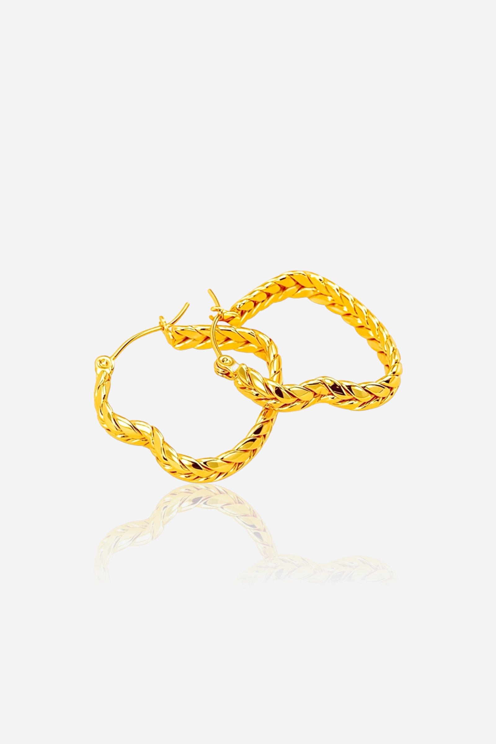 Side view braided heart hoop earrings crafted in stainless steel with a polished PVD 18K gold plated finish, showcasing a twisted heart-inspired braid design – GLISTIA