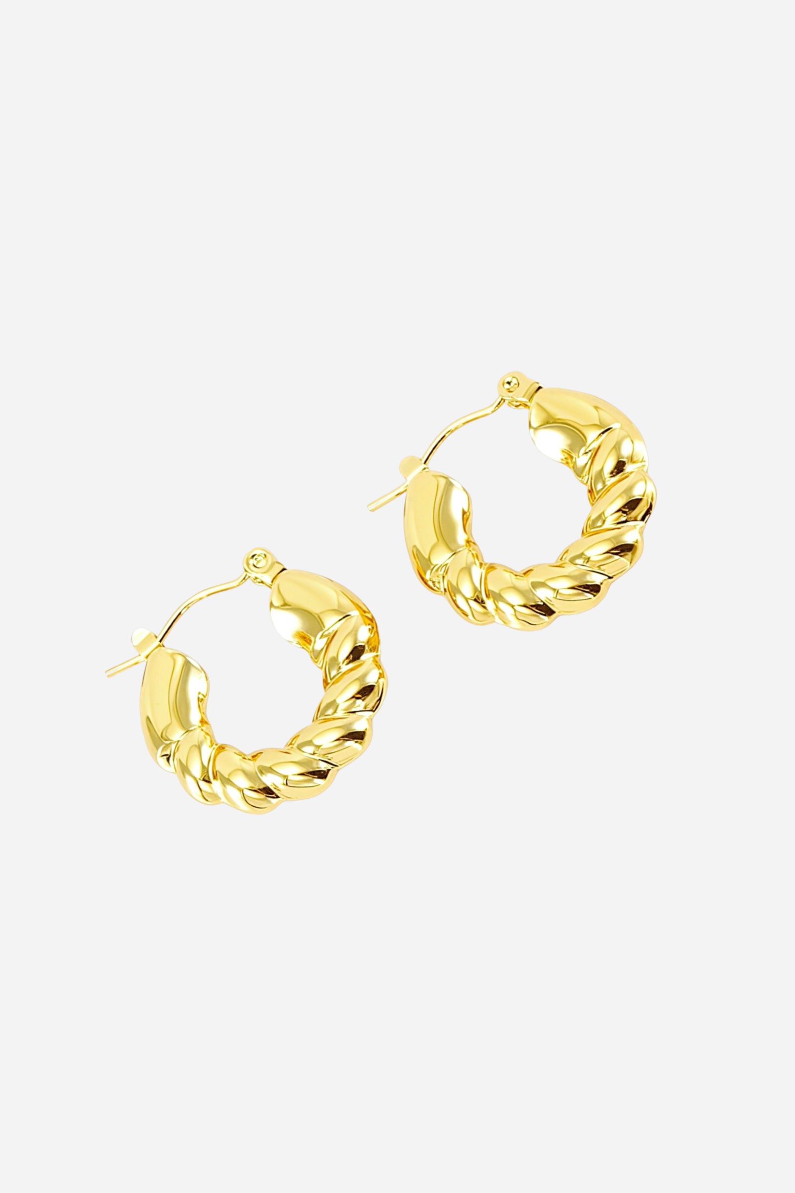 Side view of braided twist hoop earrings crafted from stainless steel with a radiant PVD 18K gold plated finish, featuring intertwined curves and a polished rounded design – GLISTIA.