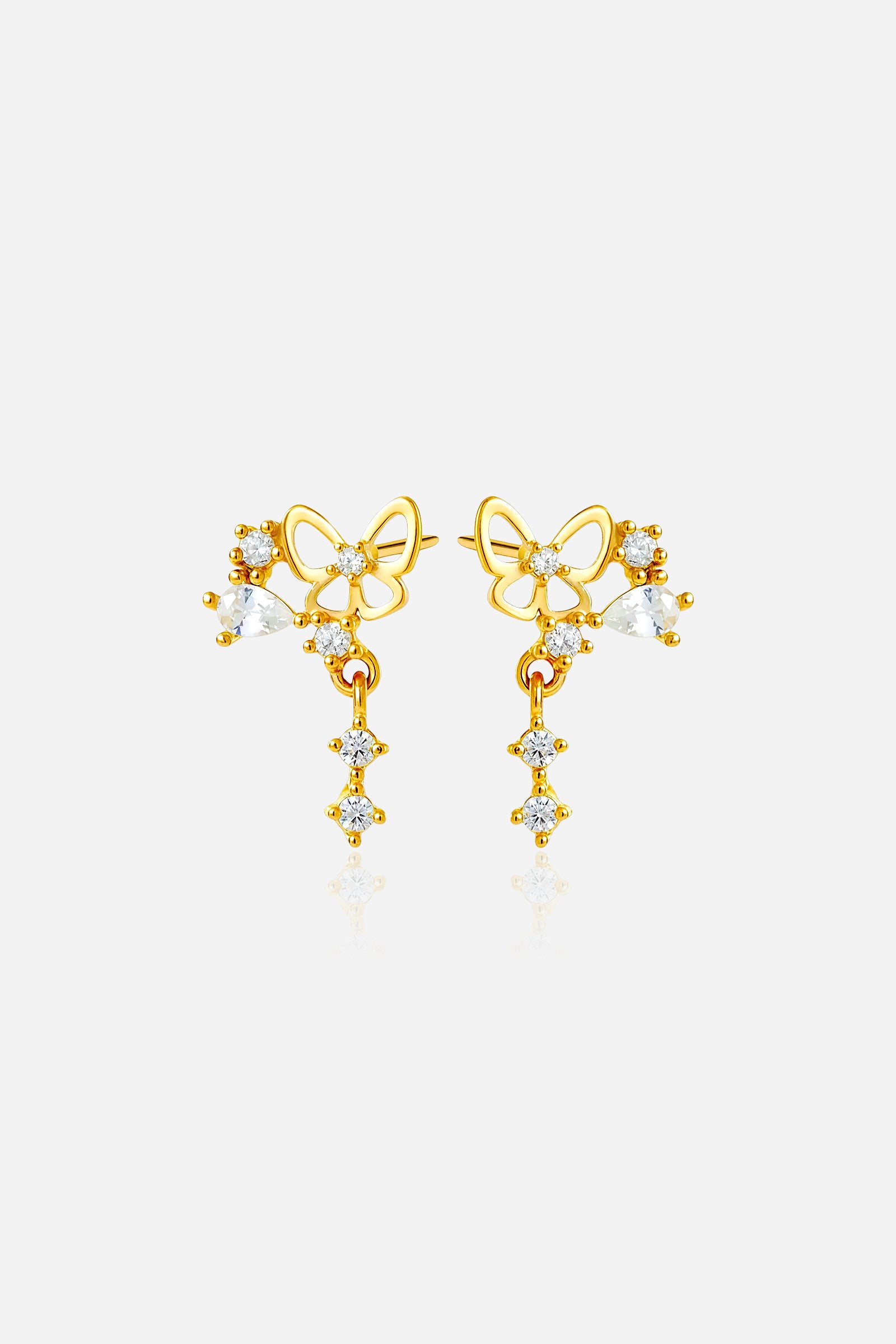 Front view of gold butterfly drop piercing stud earring with zirconia stones on model’s ear pair - GLISTIA