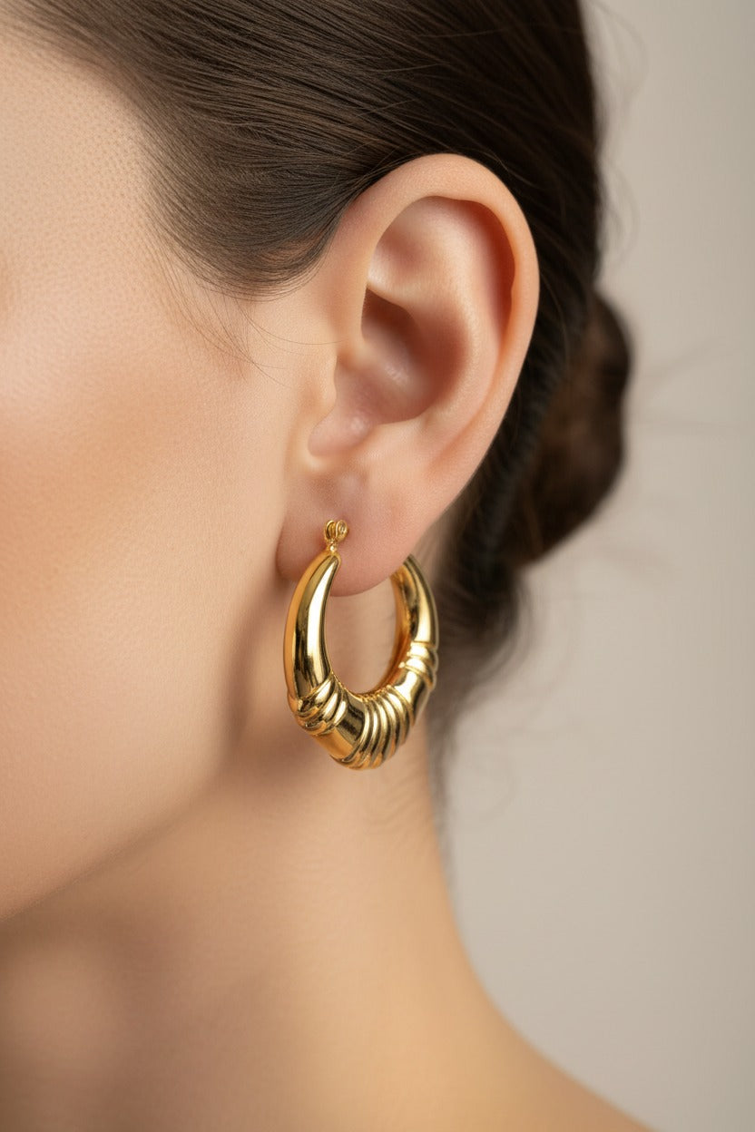 Side view of chunky ridged hoop earrings in 18K PVD gold plated stainless steel with bold rounded design
