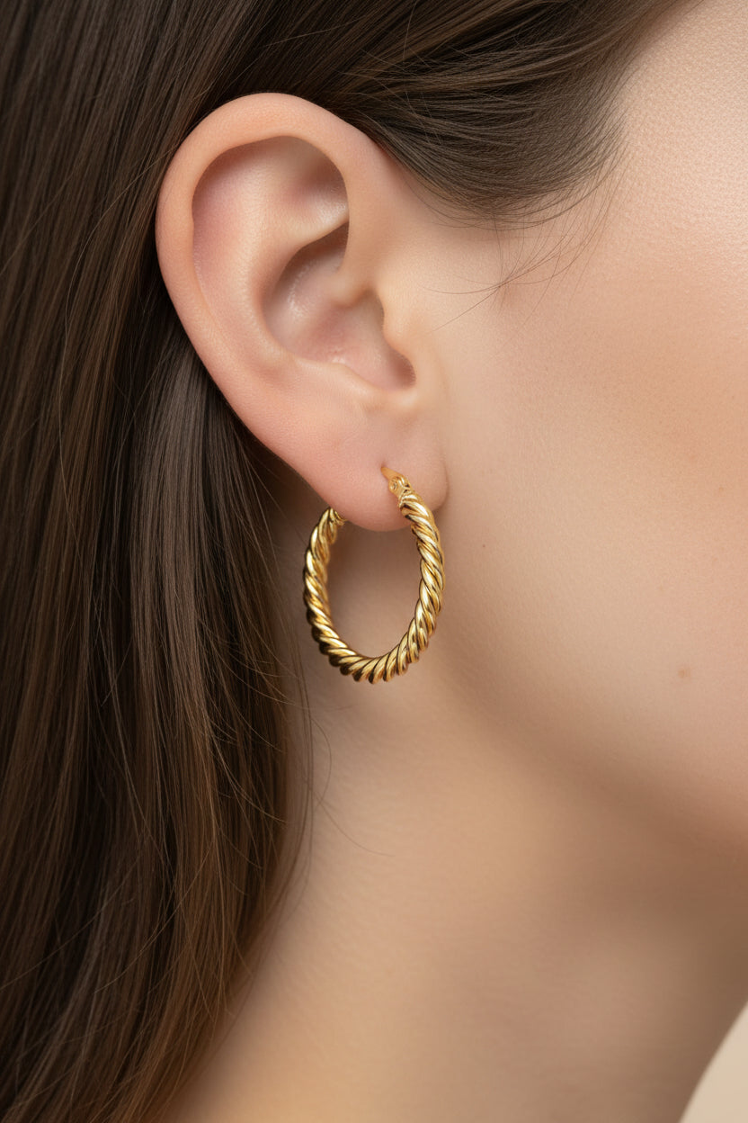 Gold twisted rope hoop earrings with polished finish and textured design