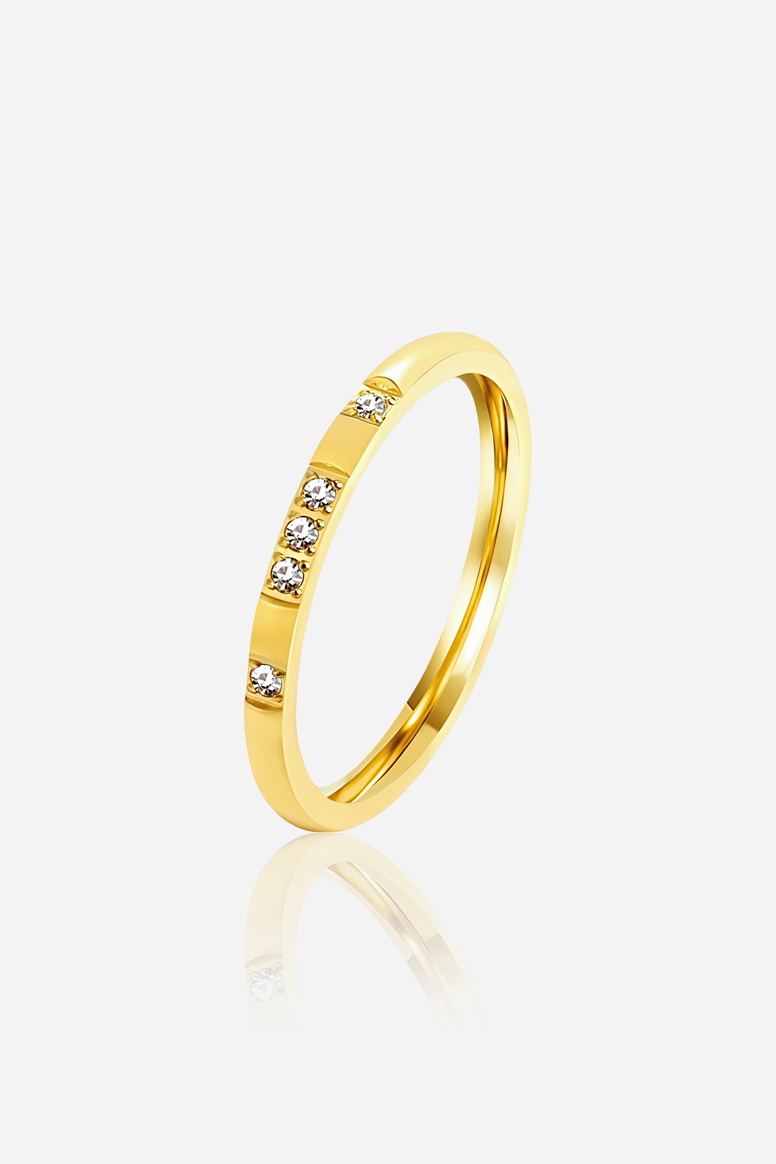 GLISTIA Crystal Accent Slim Band Ring front view in PVD 18K gold plated stainless steel with clear crystal detailing.
