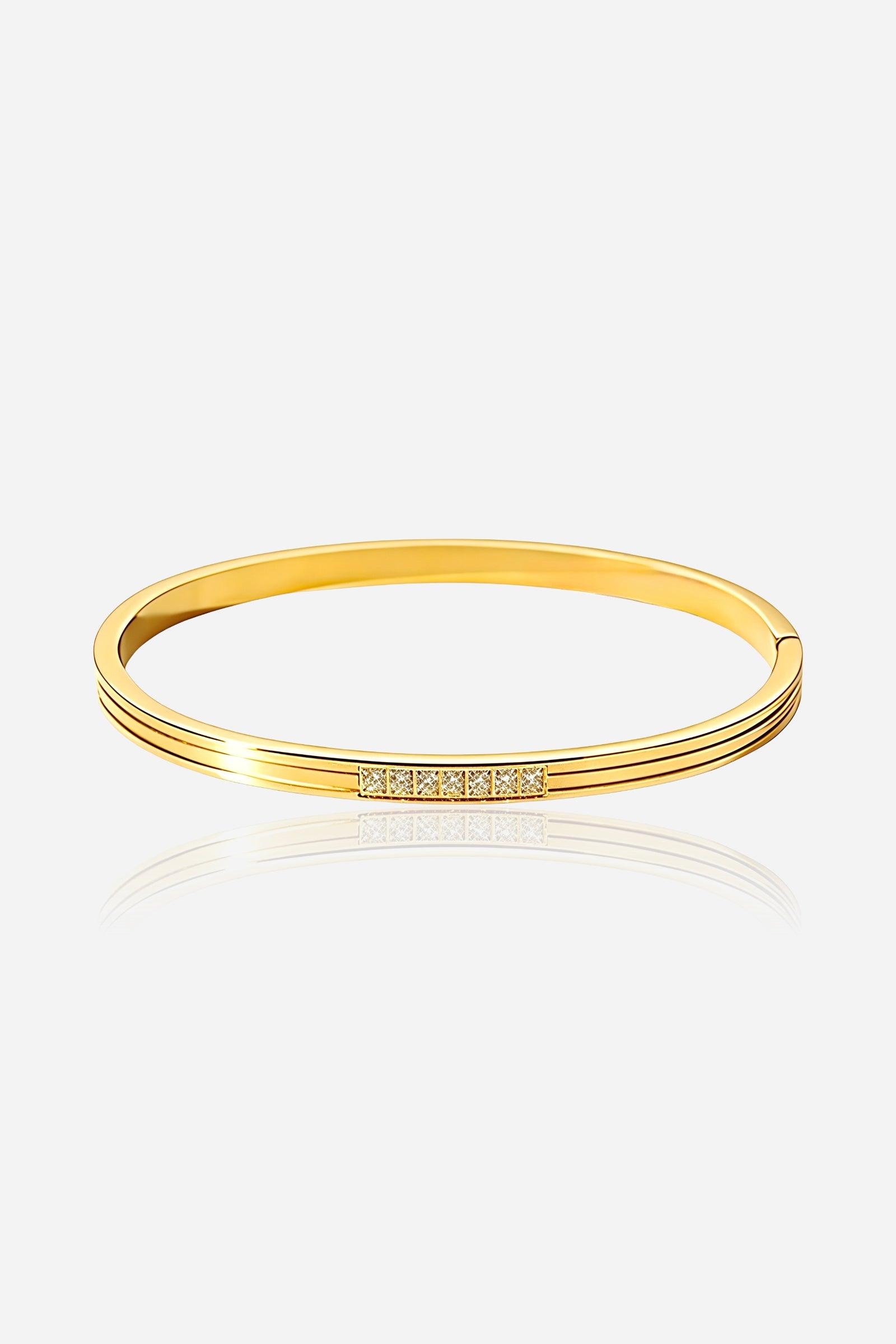 Front view of the Crystal Accent Slim Bangle in stainless steel with PVD 18K gold finish, featuring a cubic zirconia crystal bar – GLISTIA.