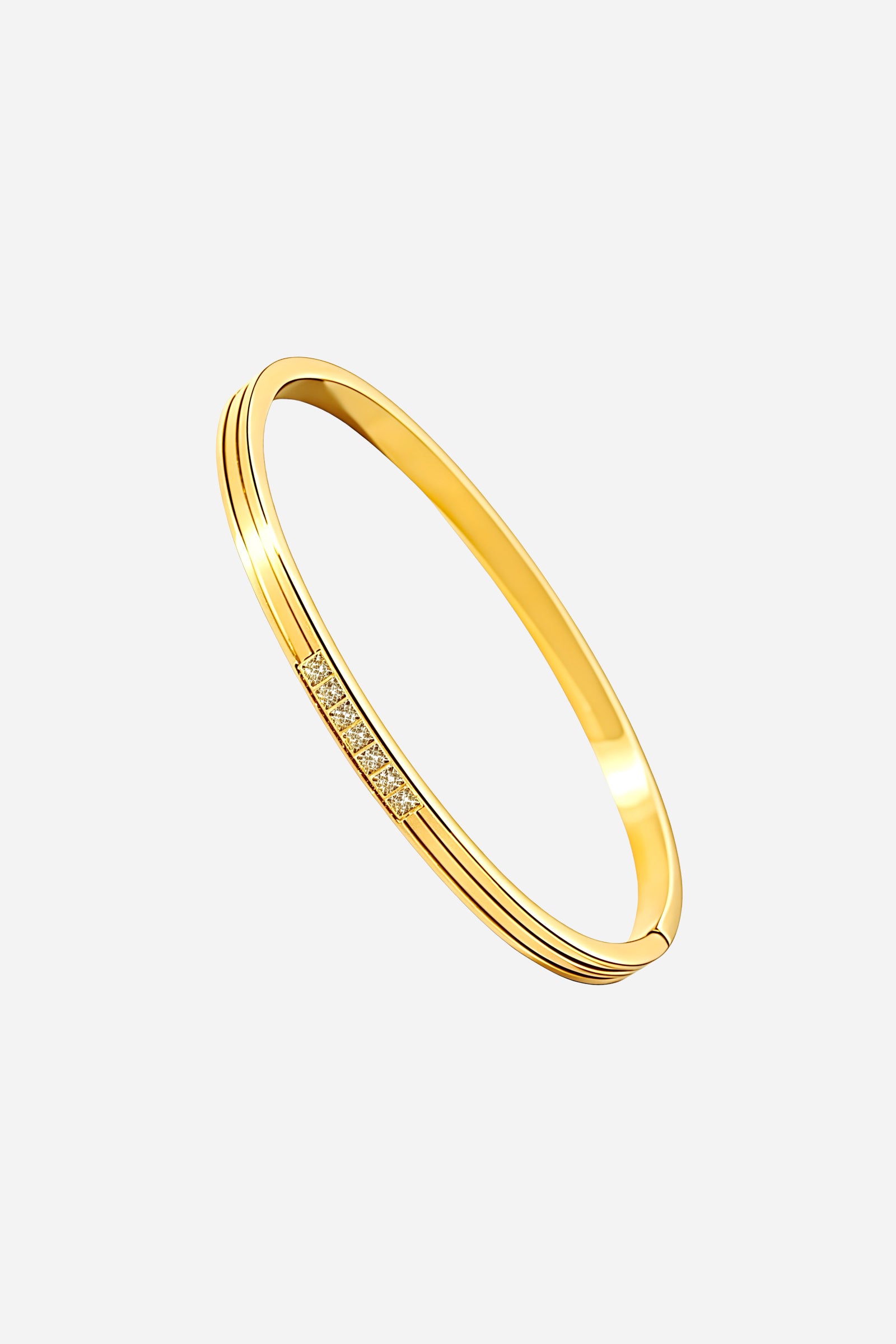 Side angle showing the sleek profile and polished gold plating of the Crystal Accent Slim Bangle with crystal detailing – GLISTIA.