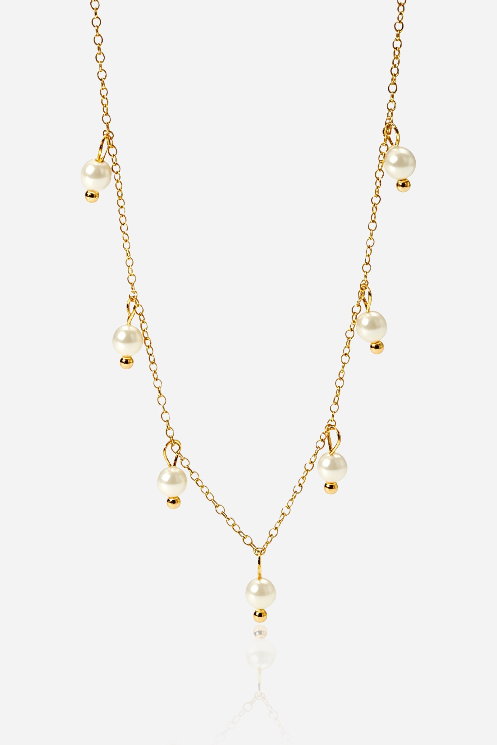 Close-up shot of GLISTIA Dewdrop pearl charm necklace showing dangling pearls and fine chain.