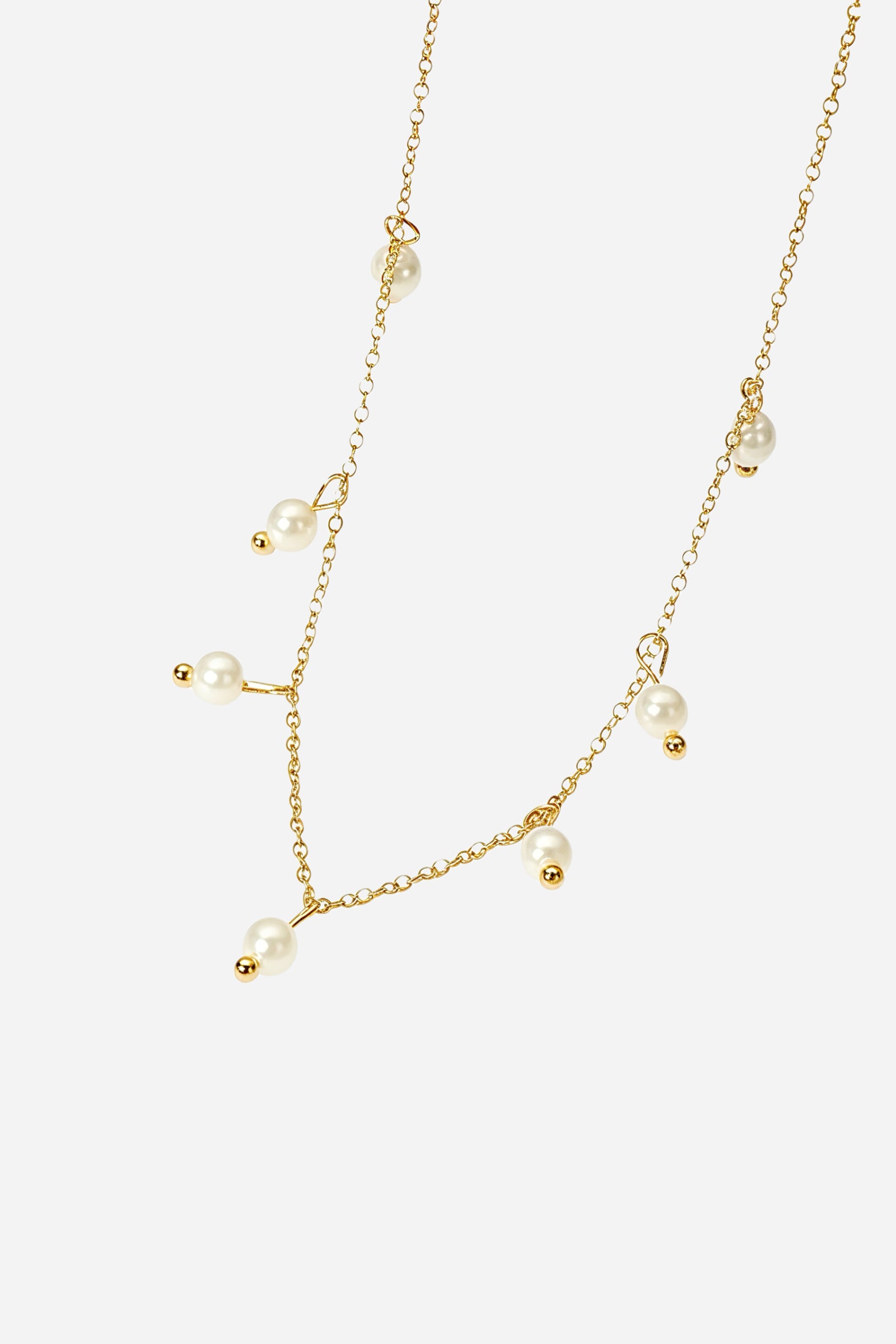 Top-view image of GLISTIA 18K gold-plated necklace featuring delicate pearl charms.