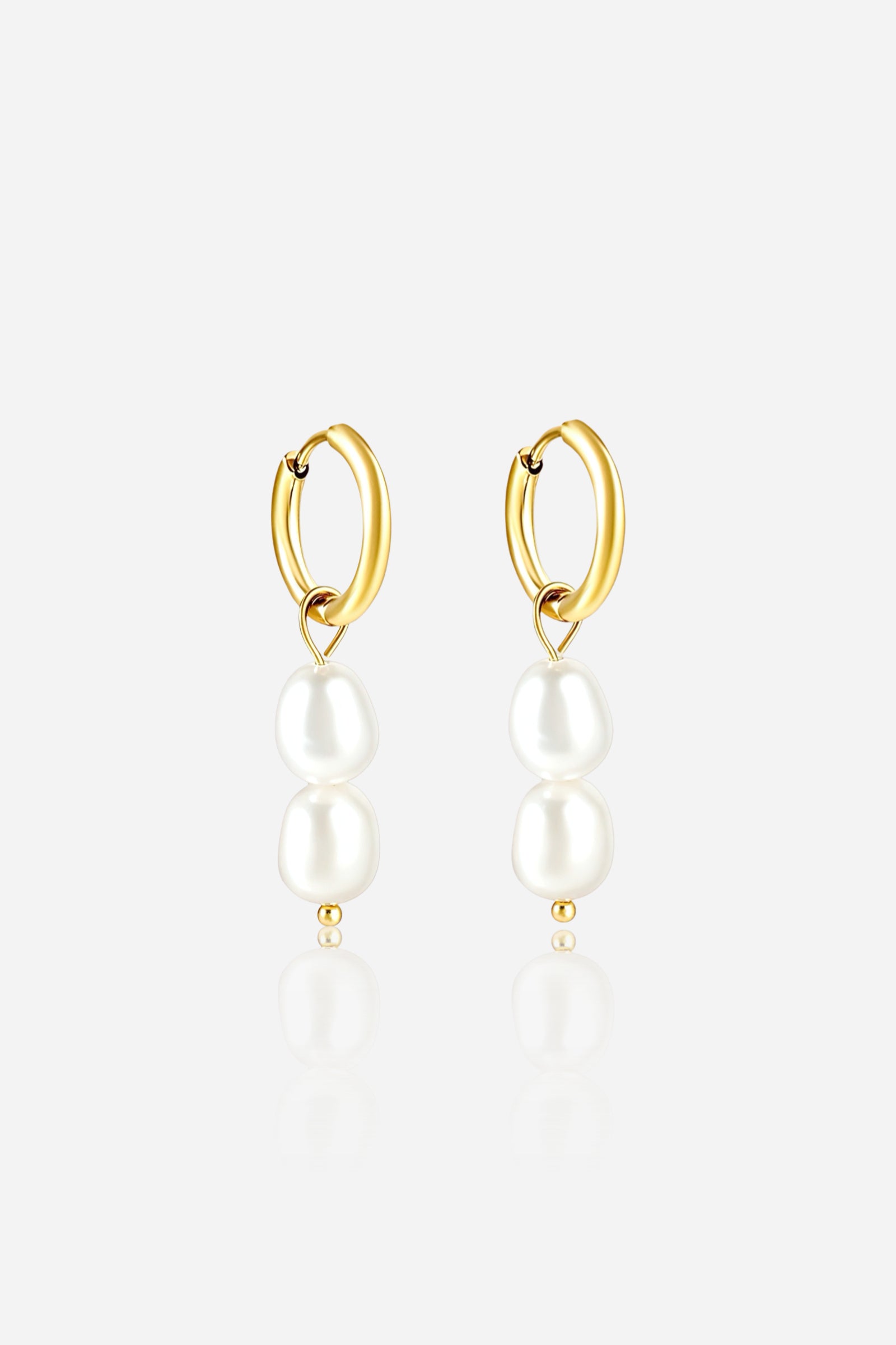 Front view of double pearl drop huggie earrings crafted from stainless steel with a lustrous PVD 18K gold plated finish, featuring two elegant white pearls suspended from classic hoops – GLISTIA.