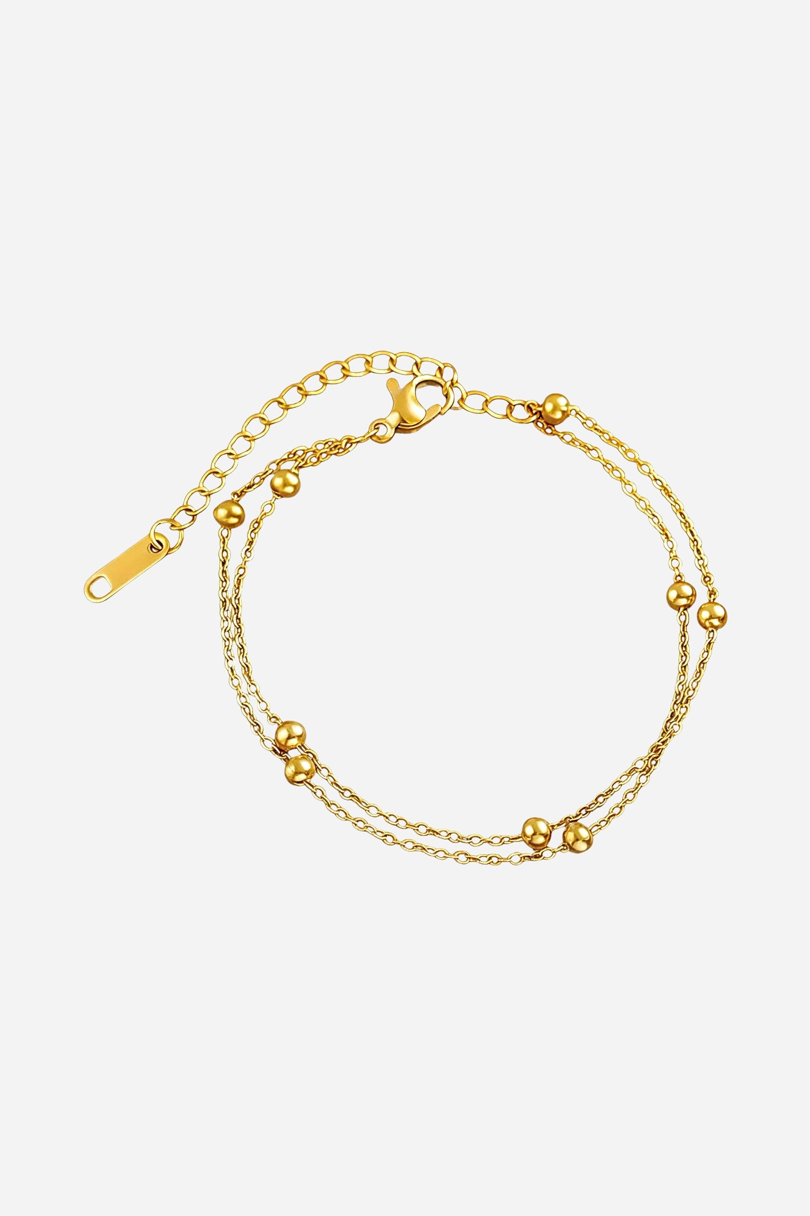 Side-angle view of the GLISTIA beaded gold bracelet highlighting the double chain design and reflective bead accents.