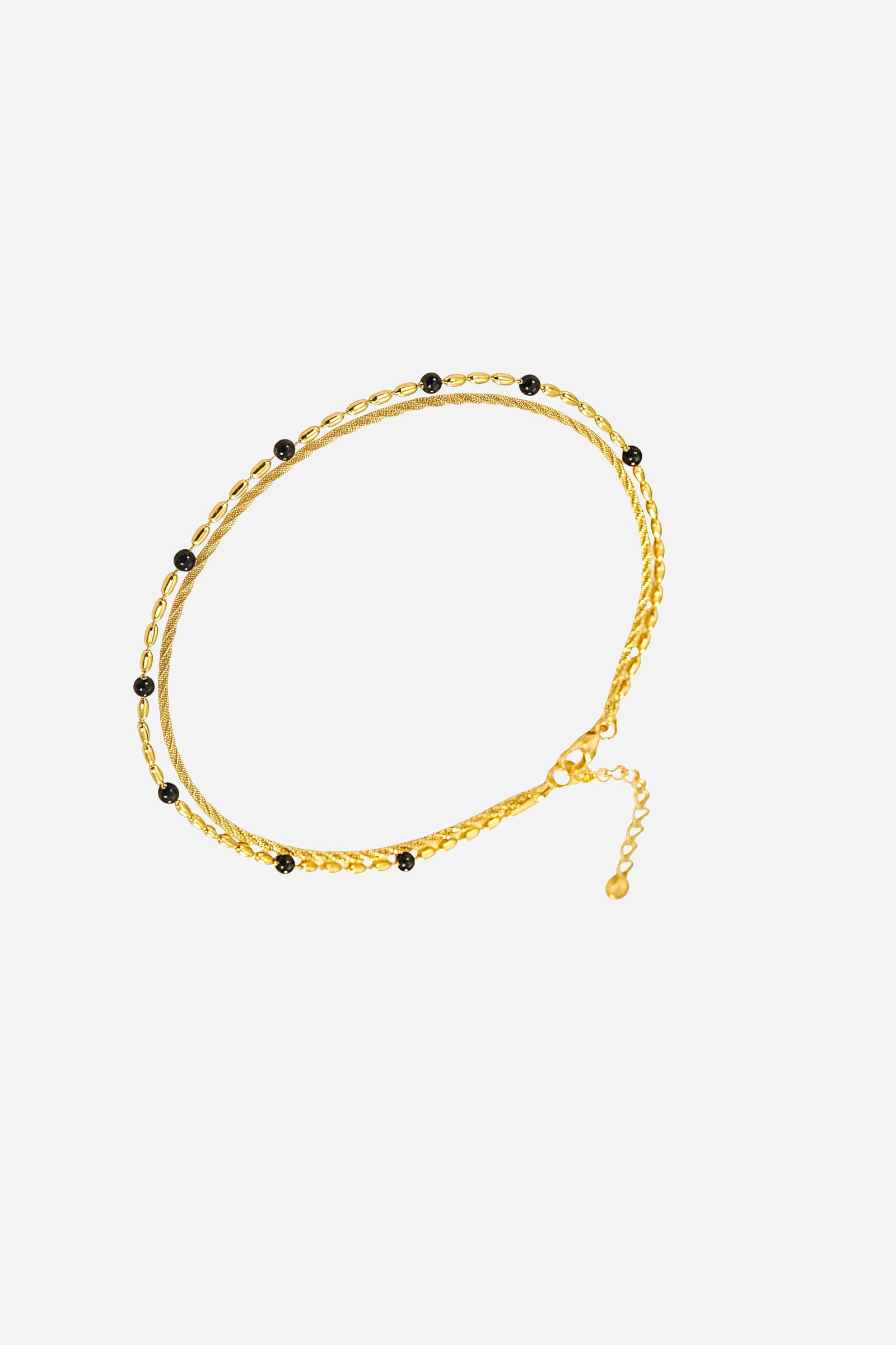 Top view of dual layer bracelet with gold chains and black bead accents, PVD 18K gold plated stainless steel - GLISTIA.
