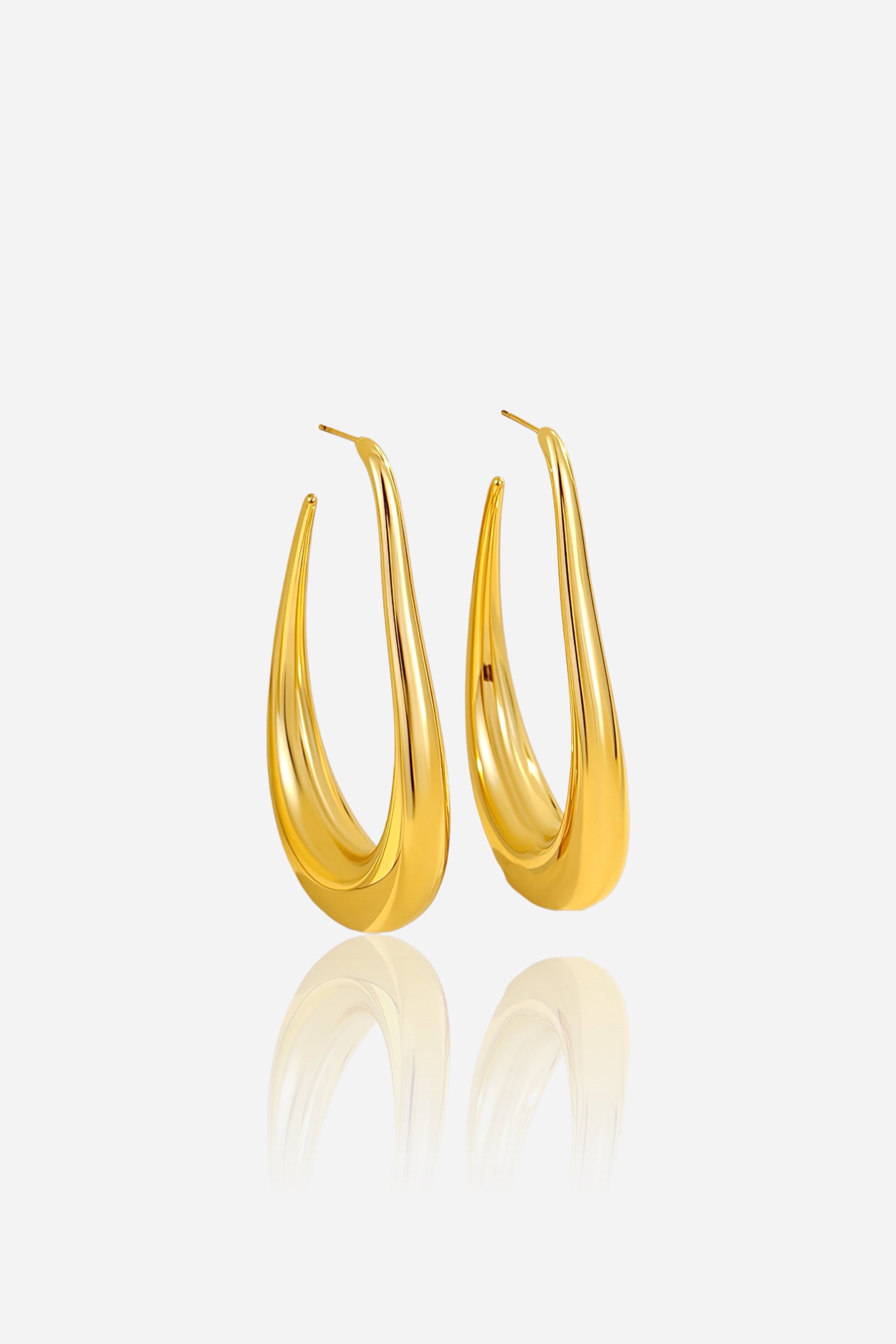 Elongated sculptural hoop earrings crafted from stainless steel with a polished PVD 18K gold-plated finish, featuring a fluid teardrop silhouette — GLISTIA.