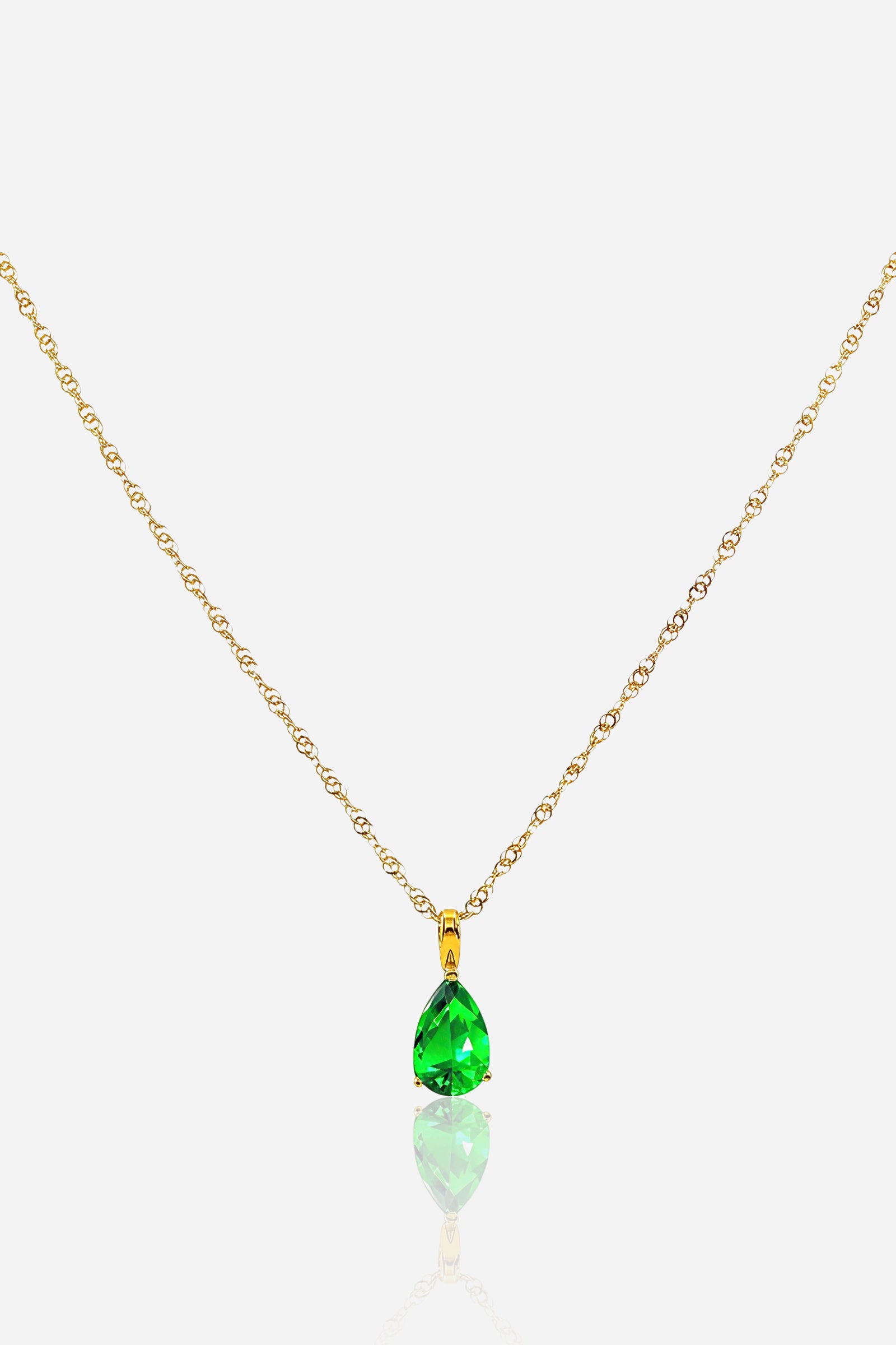 Zoom of pear-cut emerald-coloured zircon birthstone pendant showing gold-plated detailing – GLISTIA