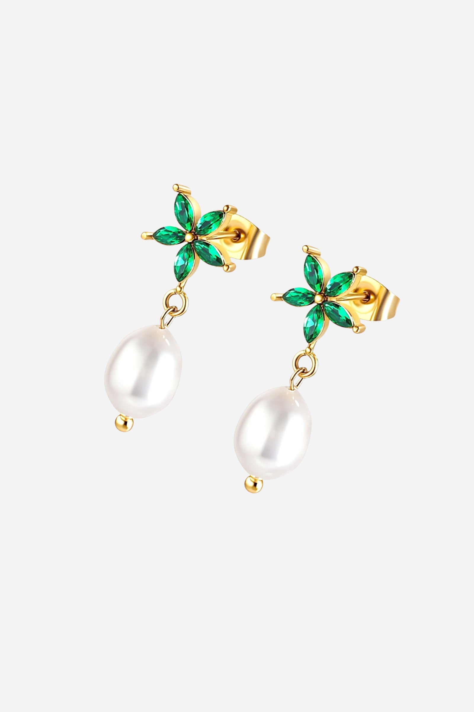 Close-up of floral emerald and pearl drop earrings crafted from stainless steel with a PVD 18K gold plated finish, featuring green gemstone petals and dangling imitation pearl — GLISTIA.
