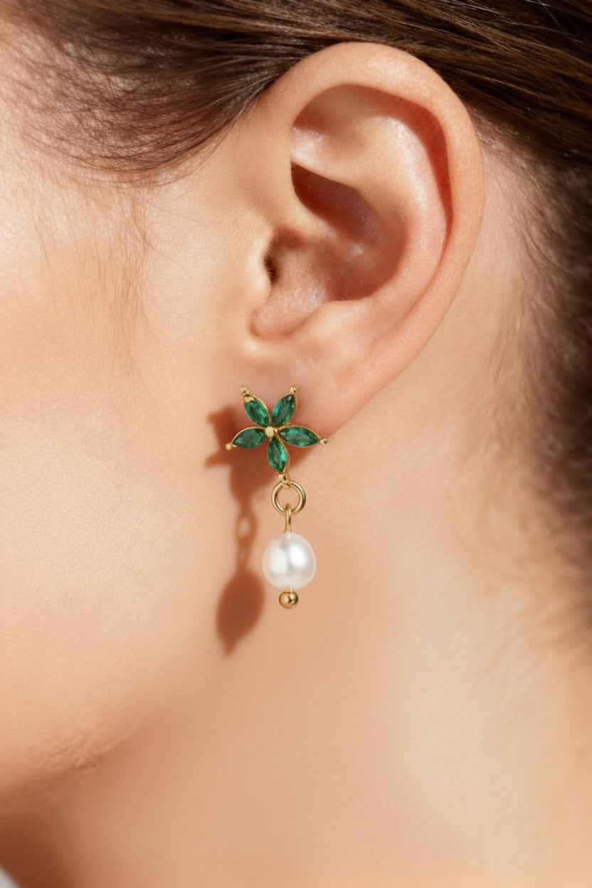 Floral emerald and pearl drop earrings worn on ear in 18K PVD gold plated stainless steel