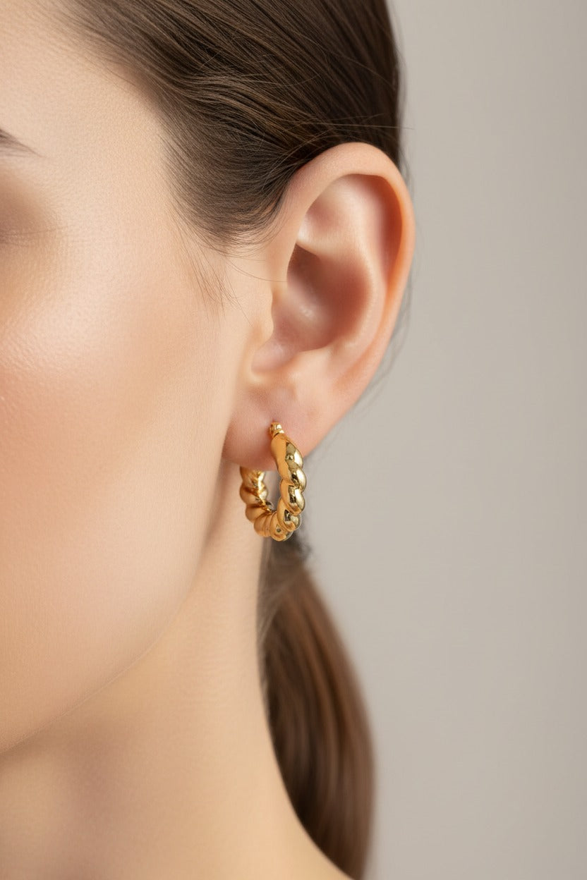 GLISTIA braided twist hoop earrings in 18K PVD gold plated stainless steel worn on ear