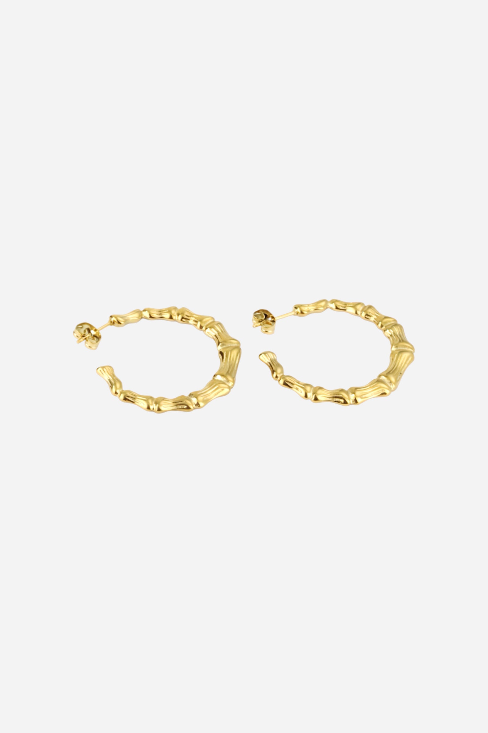 Top view of gold bamboo hoop earrings in PVD 18K gold plated stainless steel – elegant nature-inspired design by GLISTIA