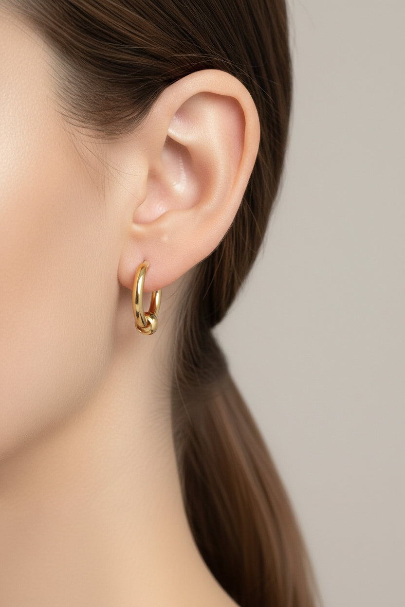 Gold bead hoop earrings crafted from stainless steel with 18K PVD gold plating, featuring a polished round bead accent and classic hoop design