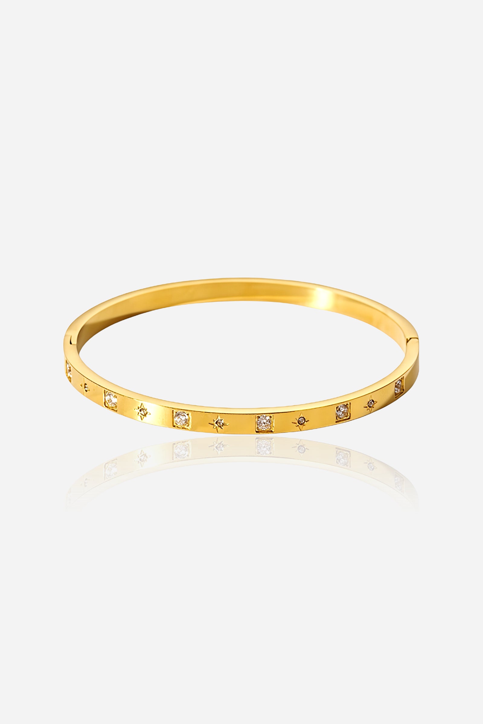 Front view of GLISTIA Gold Cubic Accent Bangle crafted from stainless steel with a radiant PVD 18K gold plating, featuring evenly spaced cubic zirconia accents along the polished band.