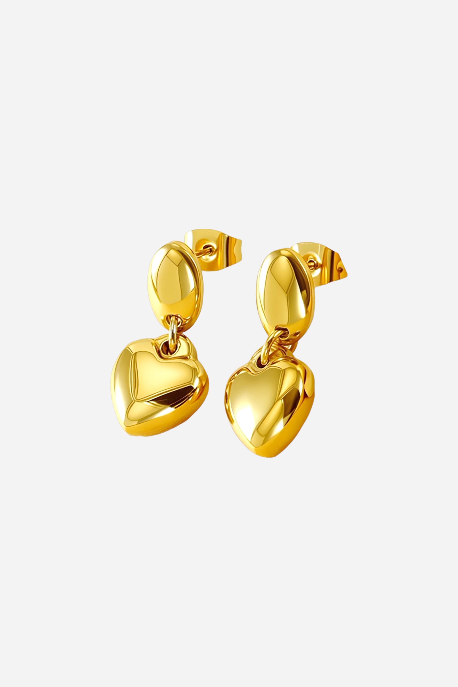 Side view of dangle heart earrings crafted from stainless steel with a lustrous PVD 18K gold plated finish, featuring polished oval studs and hanging heart drops – GLISTIA.