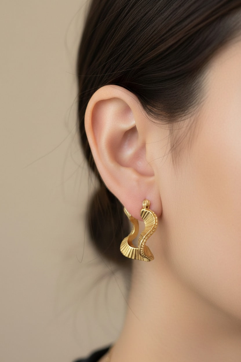 Gold geometric ripple hoop earrings crafted from stainless steel with 18K PVD gold plating, featuring a square silhouette and rippled textured finish