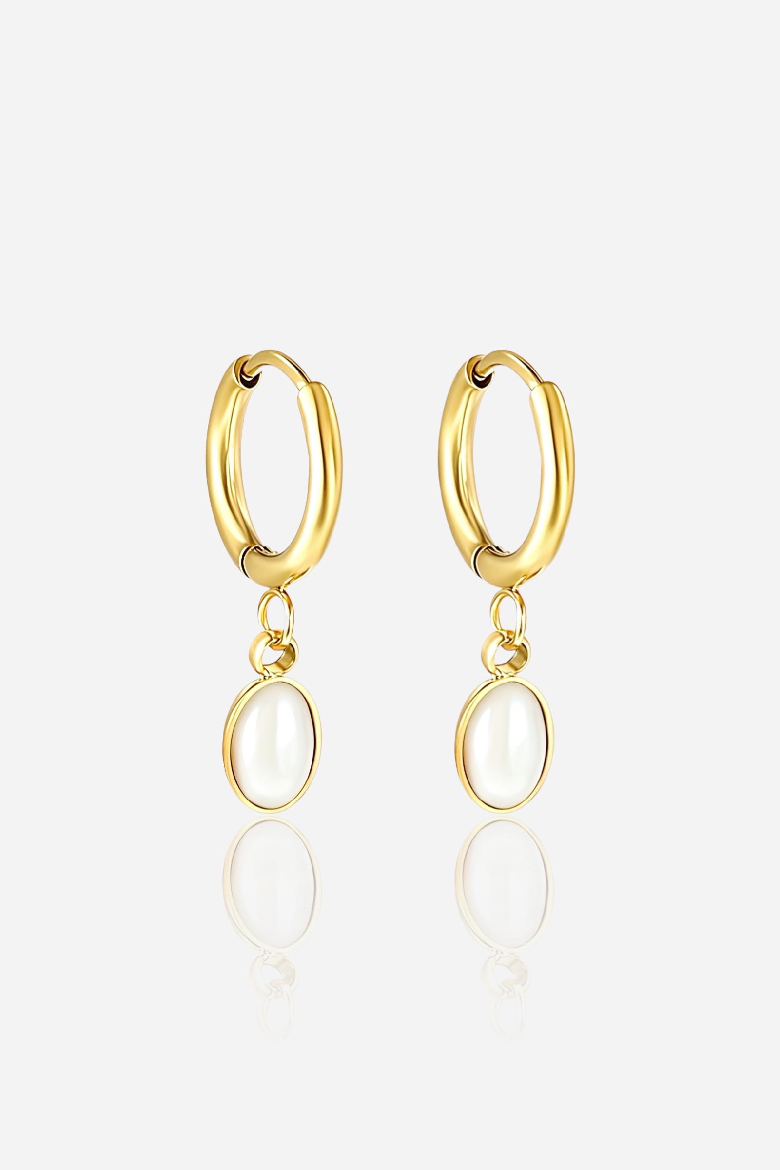 Elegant gold oval drop hoop earrings crafted from premium stainless steel with a lustrous PVD 18K gold plated finish, featuring smooth oval pearl-like drops in a minimalist modern design – GLISTIA.