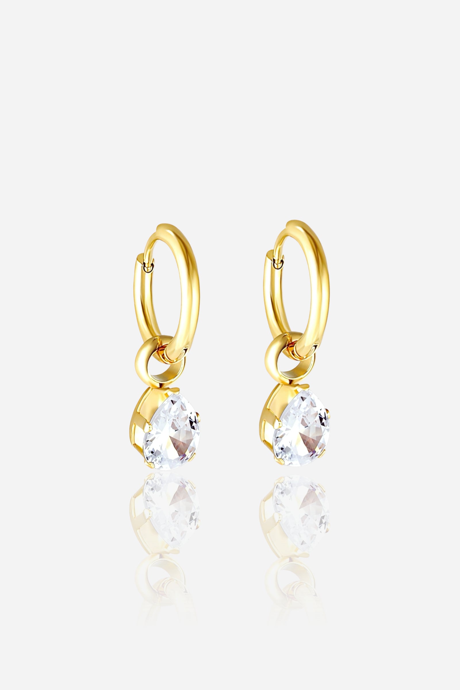 Gold hoop earrings featuring teardrop-shaped clear crystals in a polished PVD 18K gold-plated stainless-steel setting, reflecting modern elegance and luxury craftsmanship – GLISTIA.