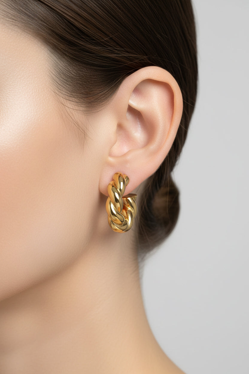 Close-up of twisted rope C-hoop earrings in 18K PVD gold plated stainless steel, showcasing a bold textured rope design and modern silhouette