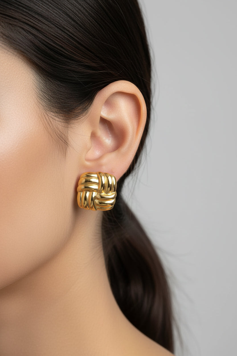 Gold woven square stud earrings crafted from stainless steel with 18K PVD gold plating, featuring a sculpted textured square design