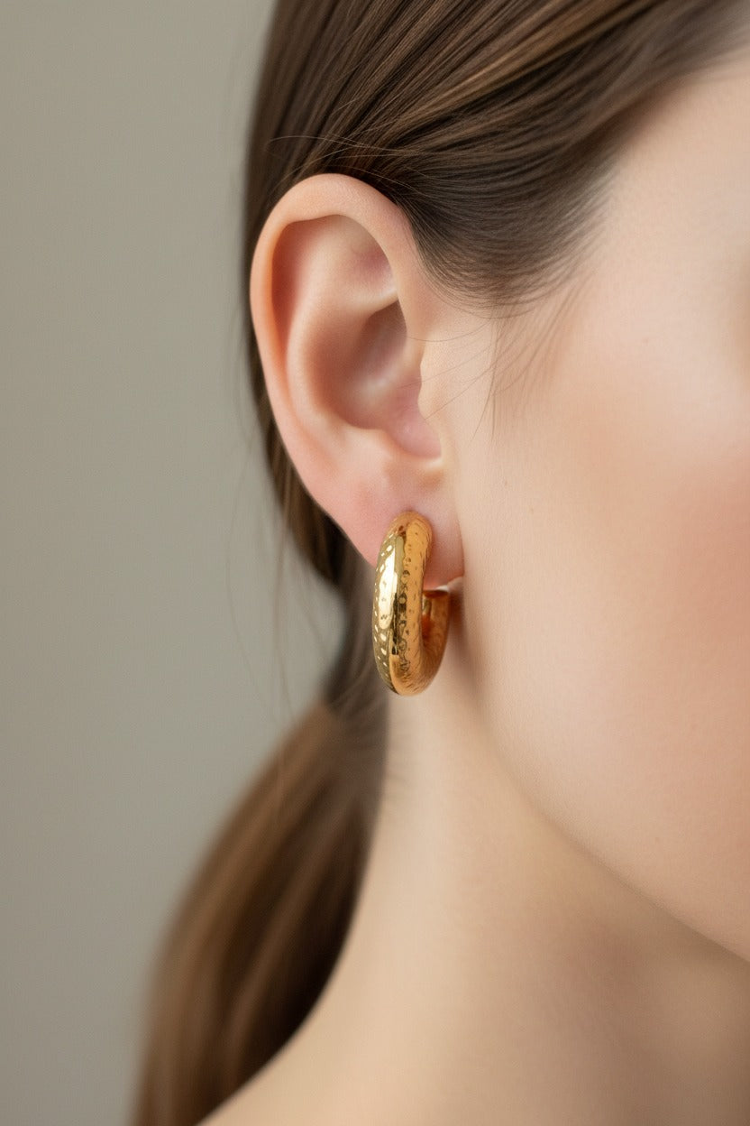 Hammered gold C-hoop earrings crafted from stainless steel with 18K PVD gold plating, featuring a textured hammered surface and bold modern silhouette
