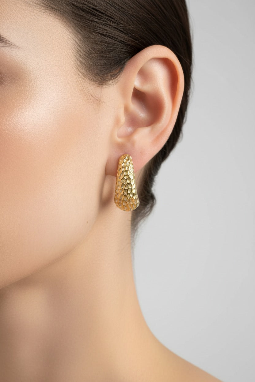Hammered gold stud earrings crafted from stainless steel with 18K PVD gold plating, featuring a curved textured design and subtle shine