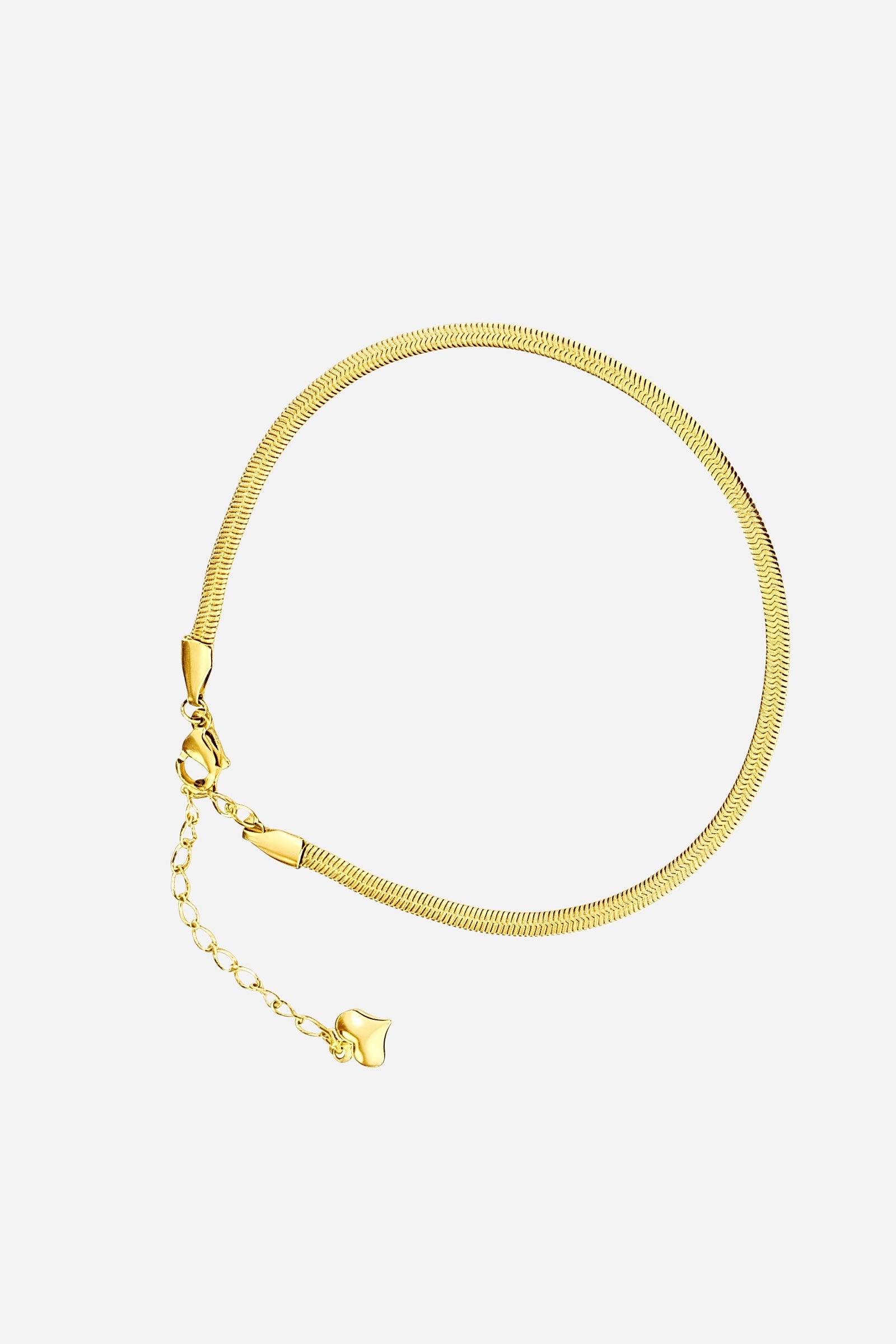 Side angle showing the shine and fluid texture of the PVD 18K gold plated herringbone anklet – GLISTIA.