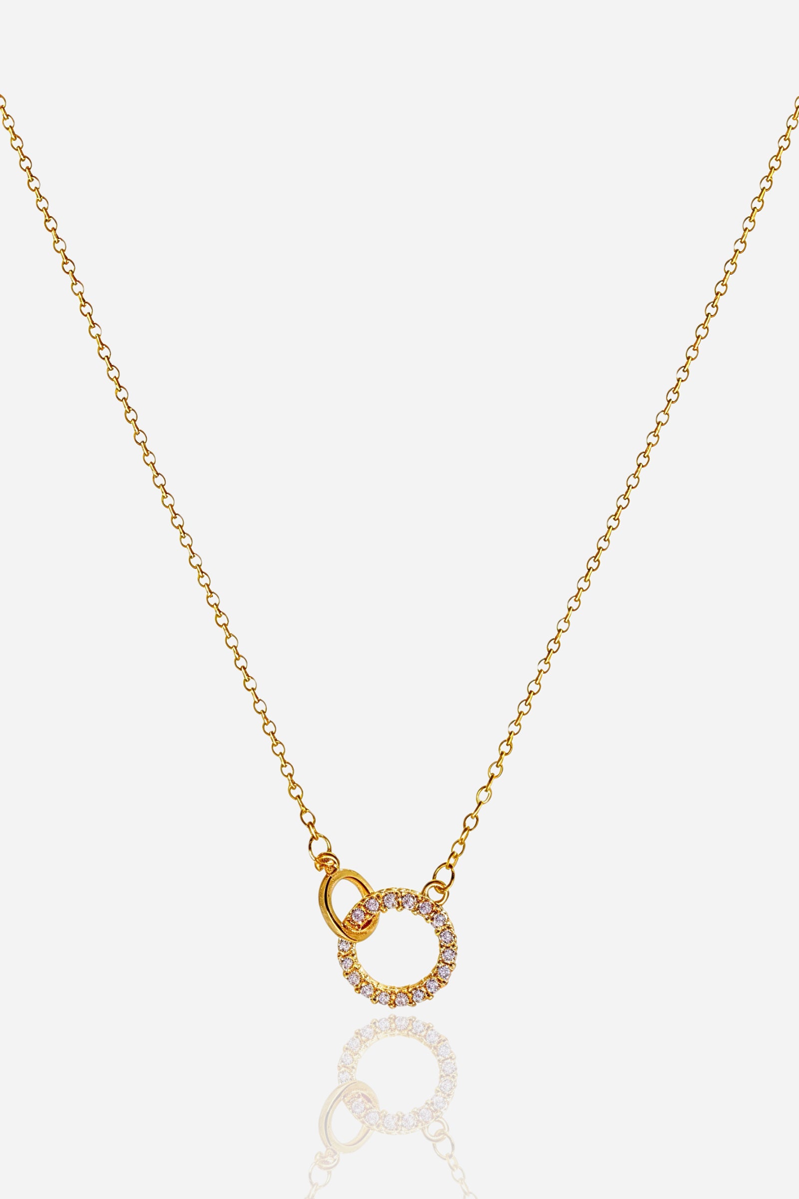 Top view of gold Interlinked Circle Necklace featuring dual rings and crystal detailing – GLISTIA