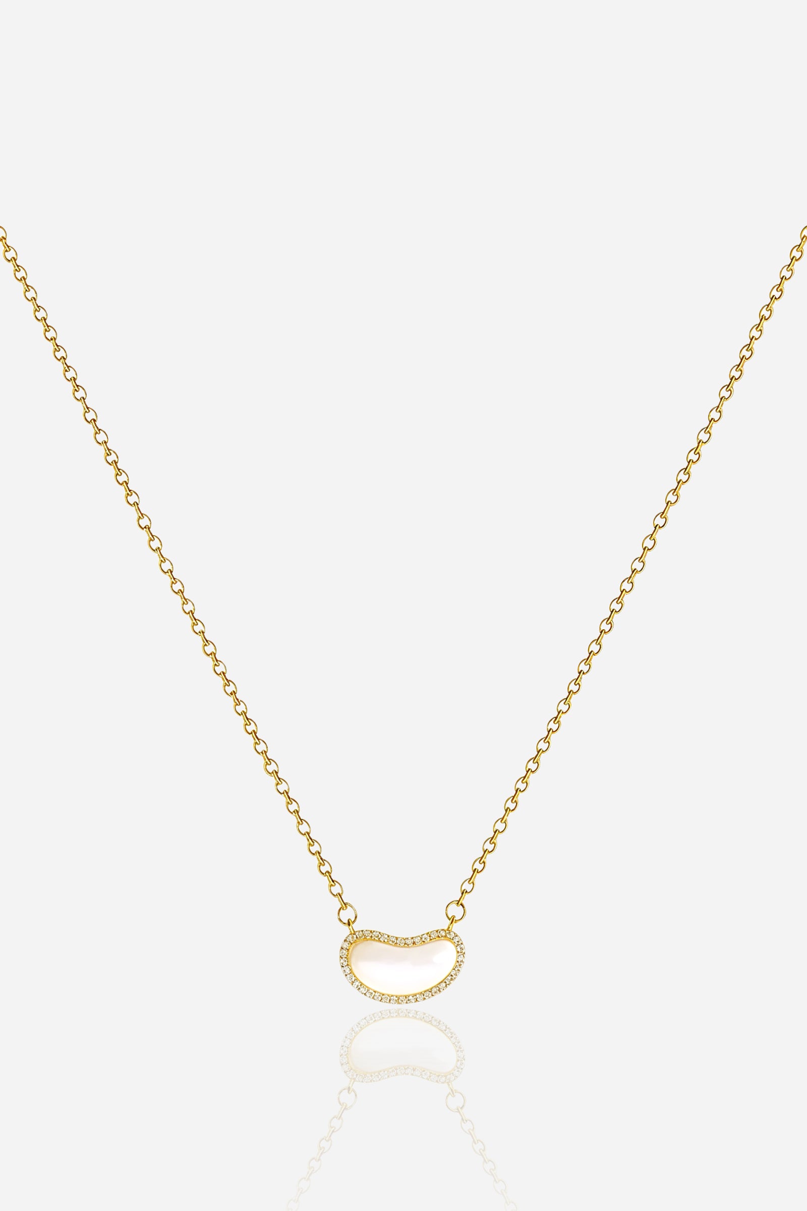 Top view of the Luna Bean Pendant Necklace showing the polished gold chain and crystal-outlined bean pendant – GLISTIA.