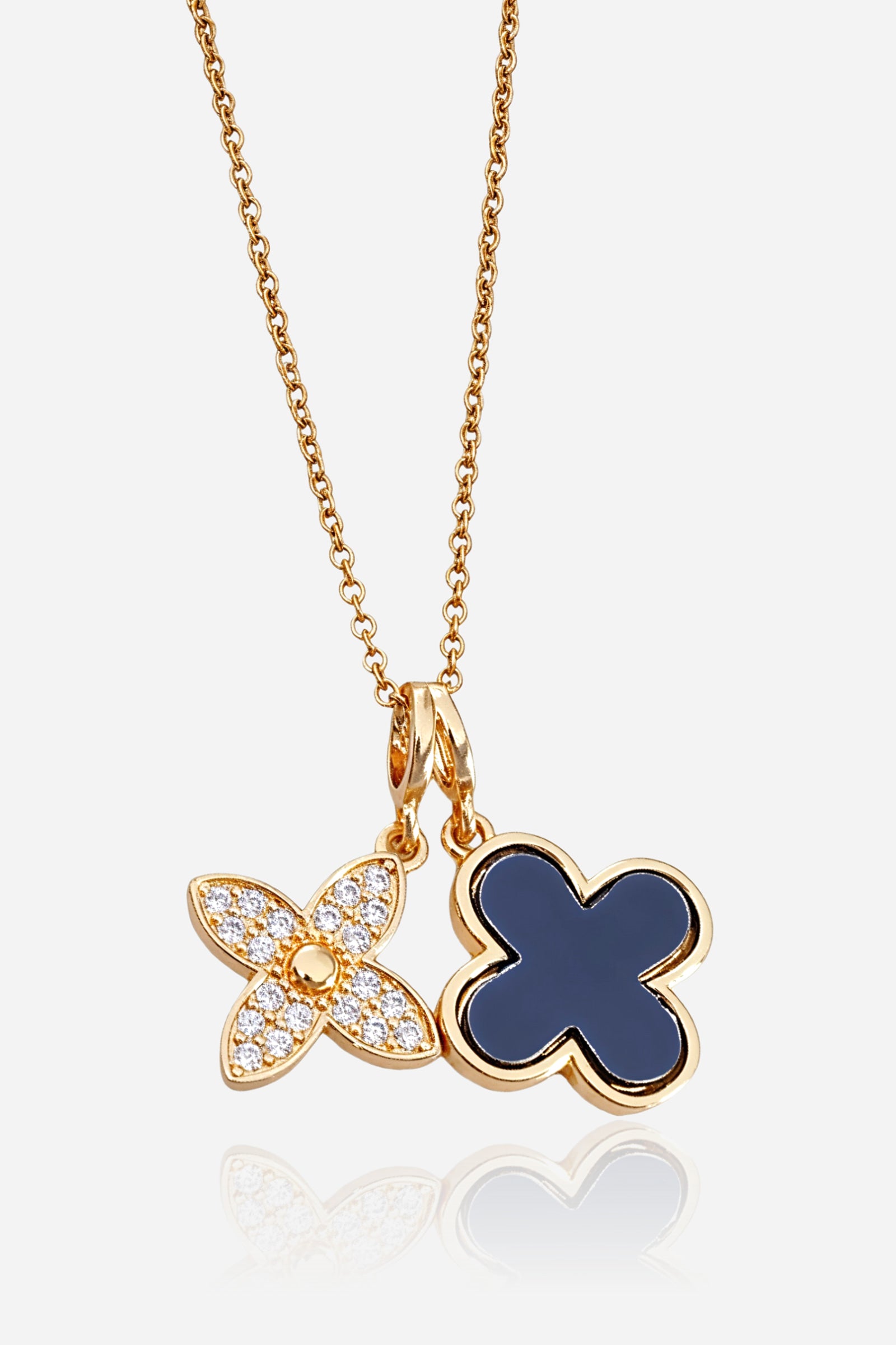 Close-up shot of GLISTIA necklace featuring pavé crystal clover and black enamel charm.