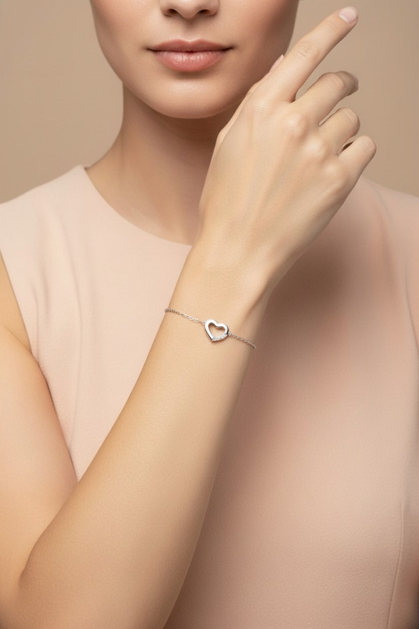 Close-up of silver stainless steel open heart minimalist bracelet with elegant fine chain detailing
