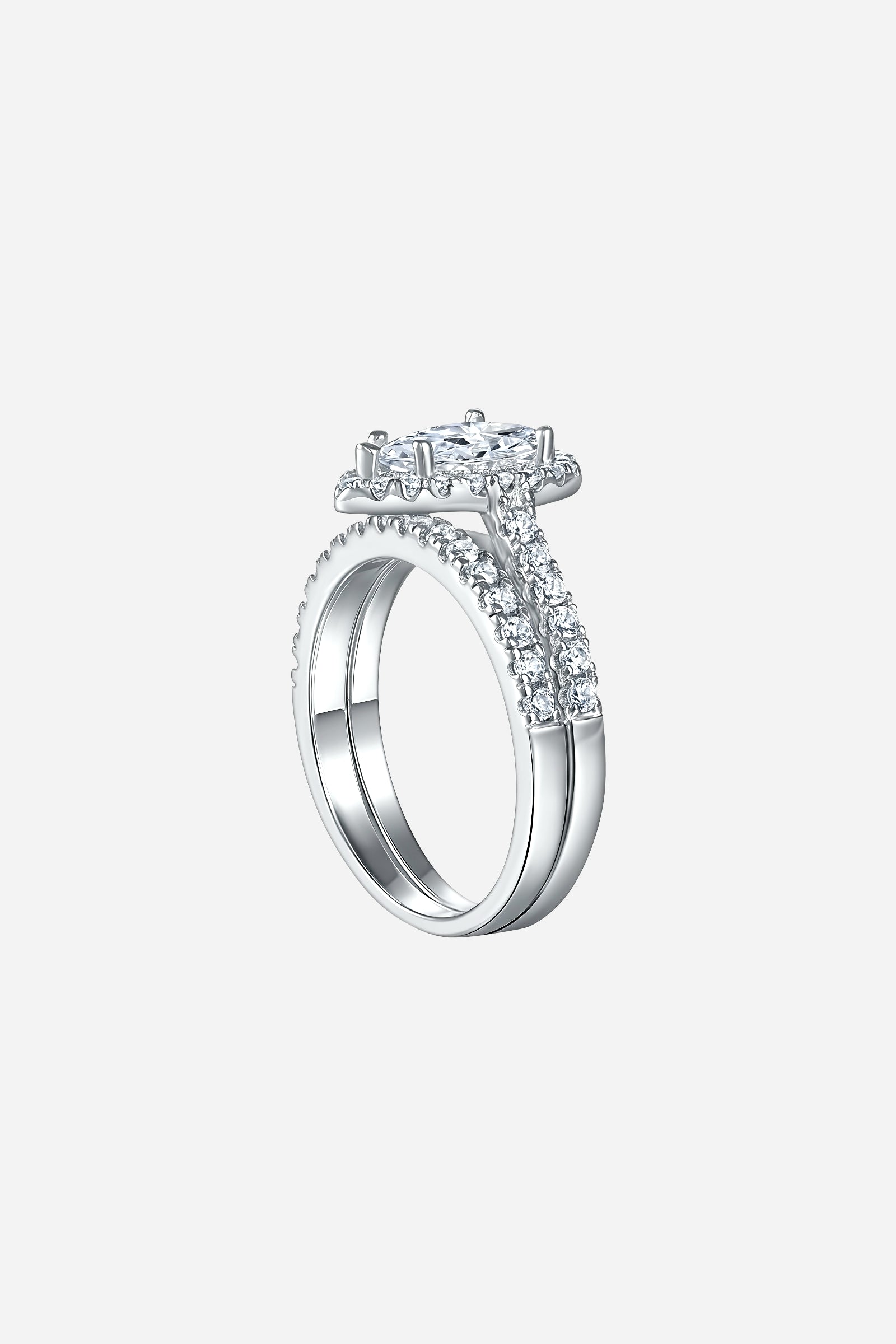 Side-angle image of GLISTIA Pear-Cut Zircon Double Band Ring Set showcasing the raised prong setting and dual pavé bands.