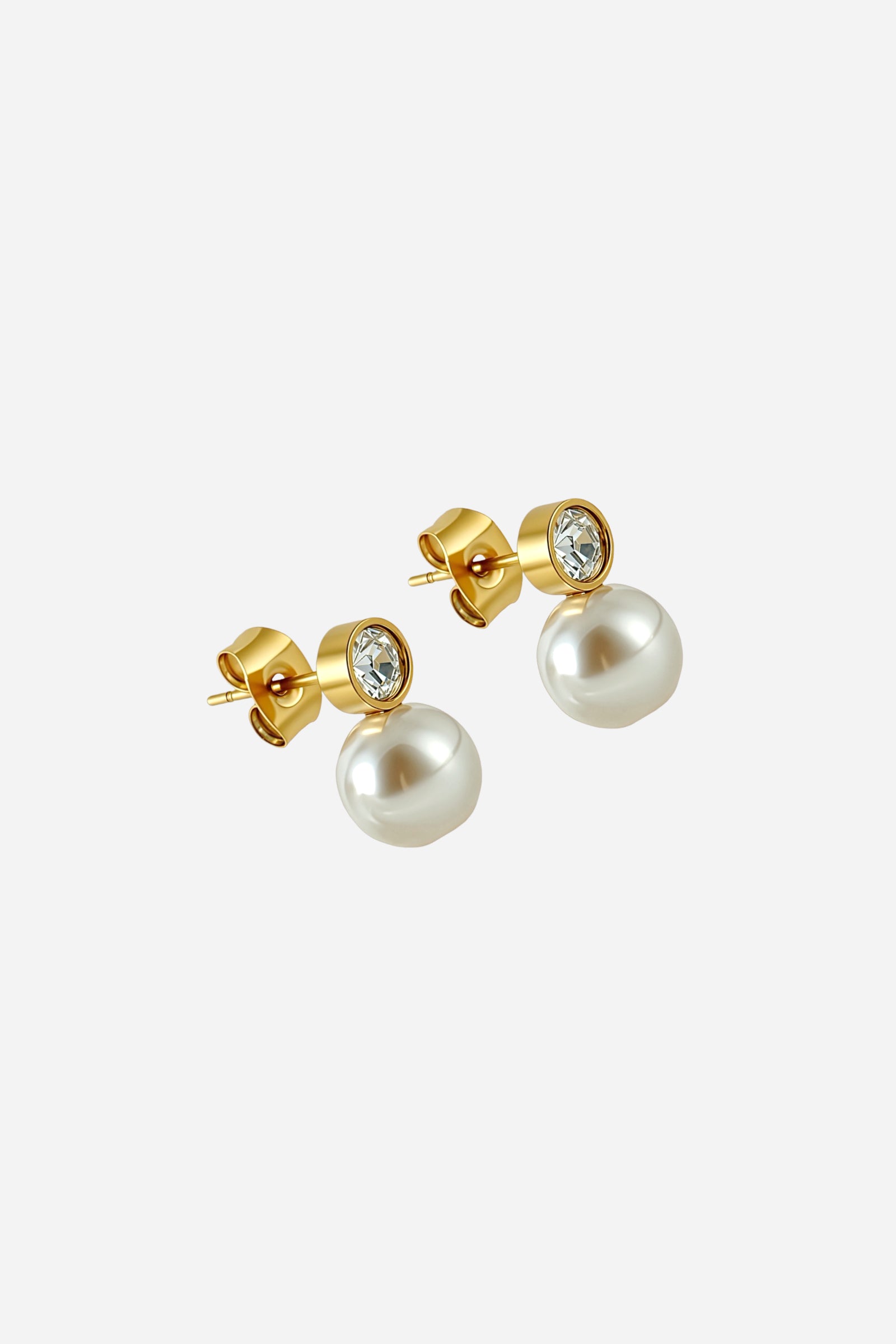 Angled view of elegant pearl drop earrings featuring lustrous imitation pearls beneath crystal rhinestone studs, crafted in stainless steel with a PVD 18K gold plated finish – GLISTIA.